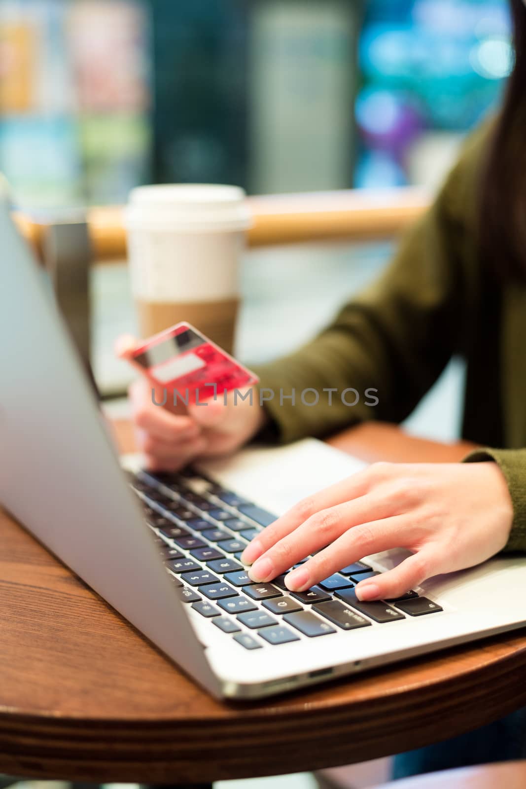 Woman typing on laptop computer for online shopping