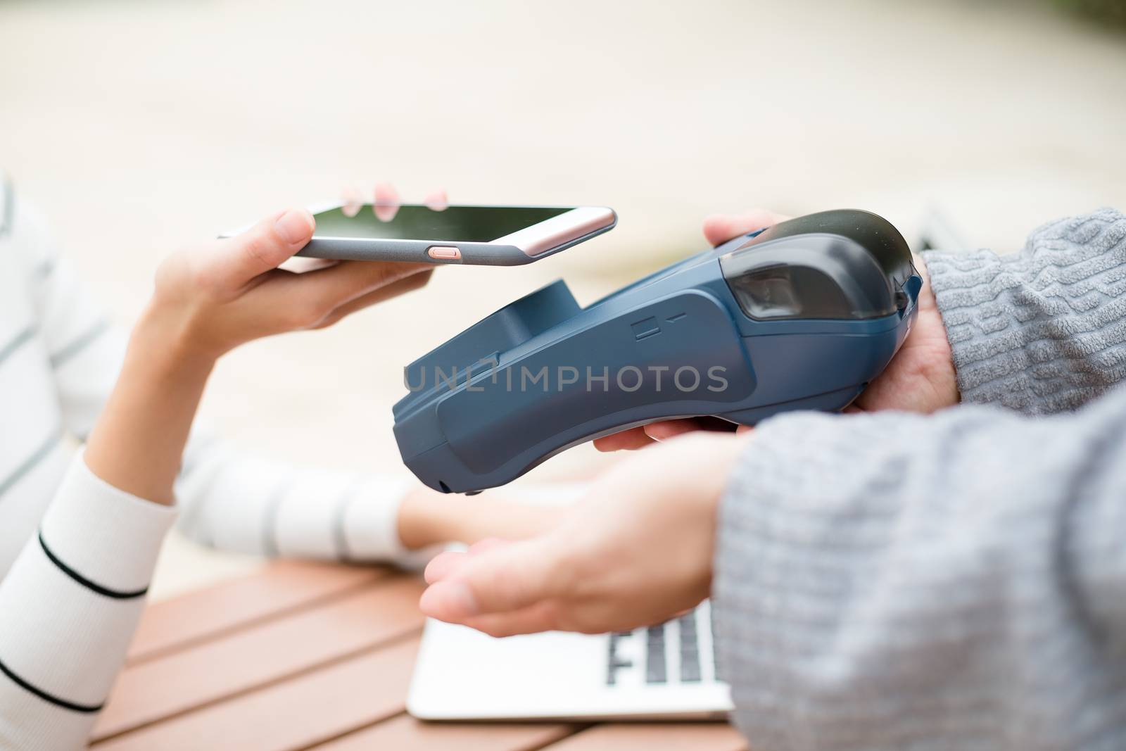 Woman using mobile phone to pay