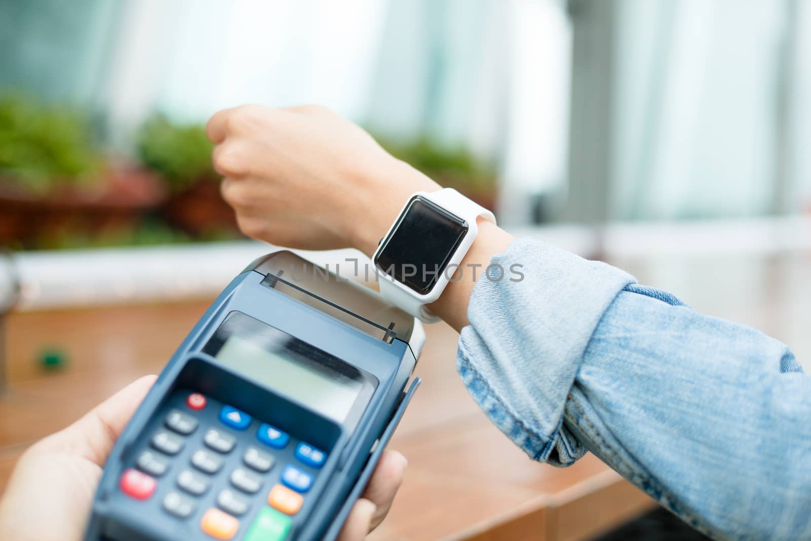 Customer paying through smart watch by leungchopan