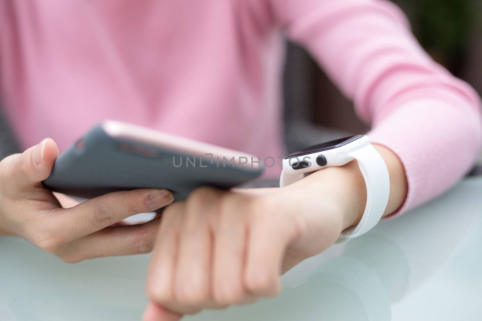 Woman use of smart watch and cellphone