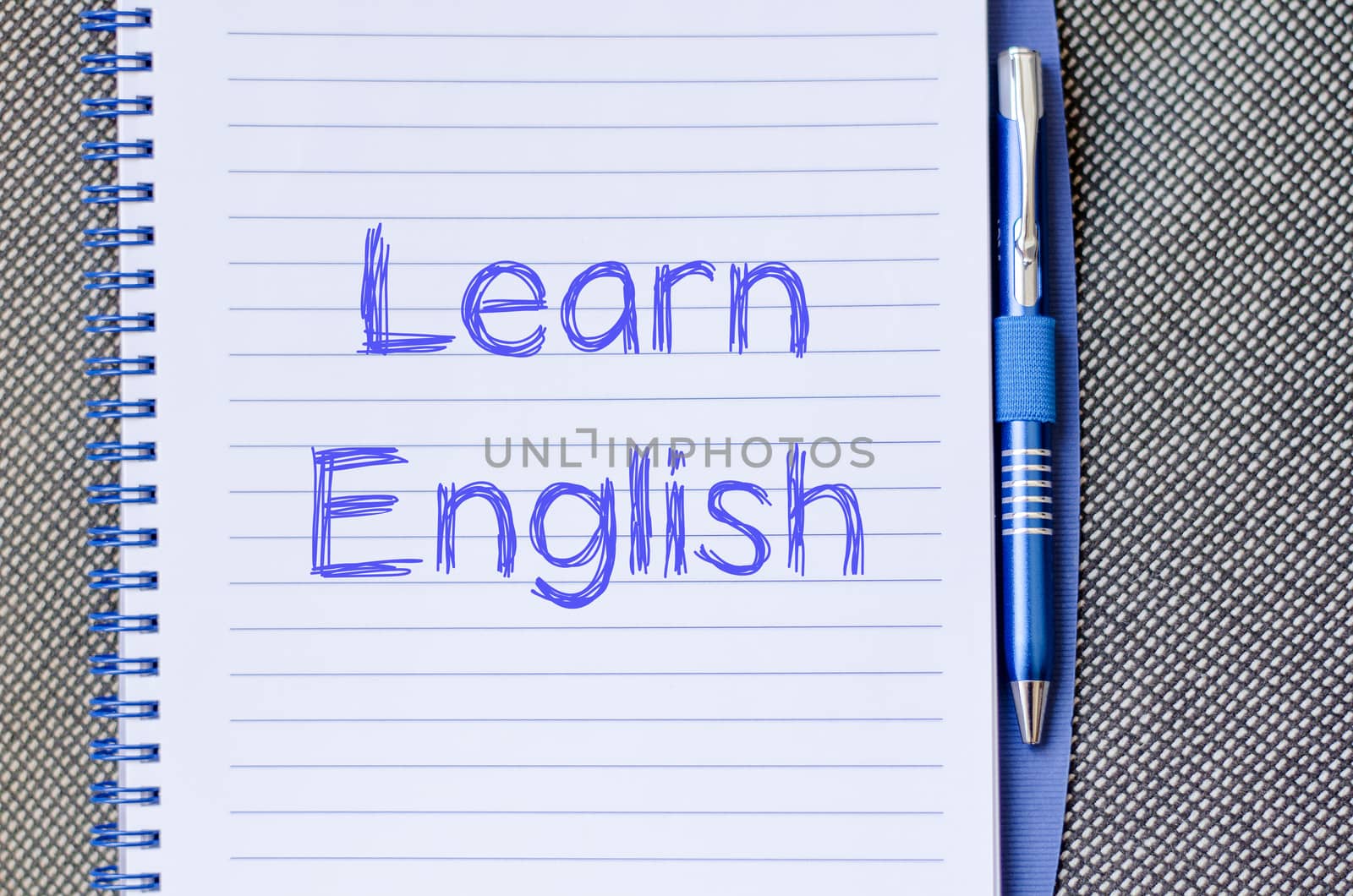 Learn english text concept write on notebook with pen