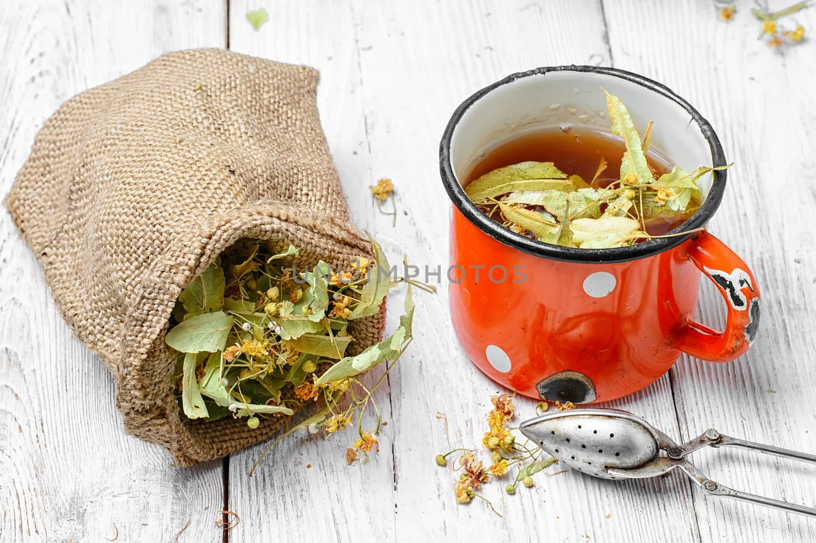 Iron mug of tea brewed with dried medicinal inflorescence of Linden