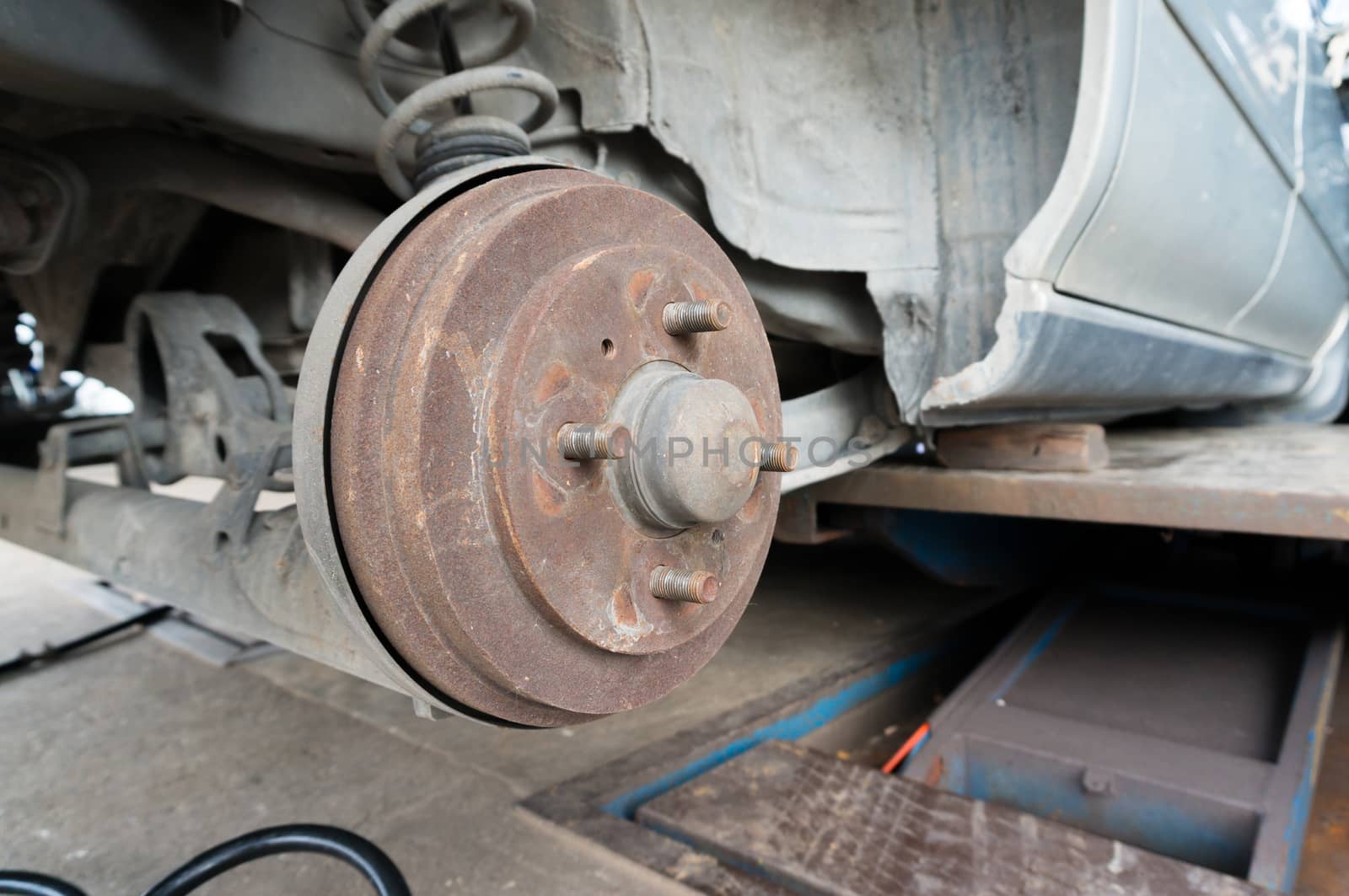 Rusty Rear Car Wheel Hub with Drum Brake System and Suspension by thampapon