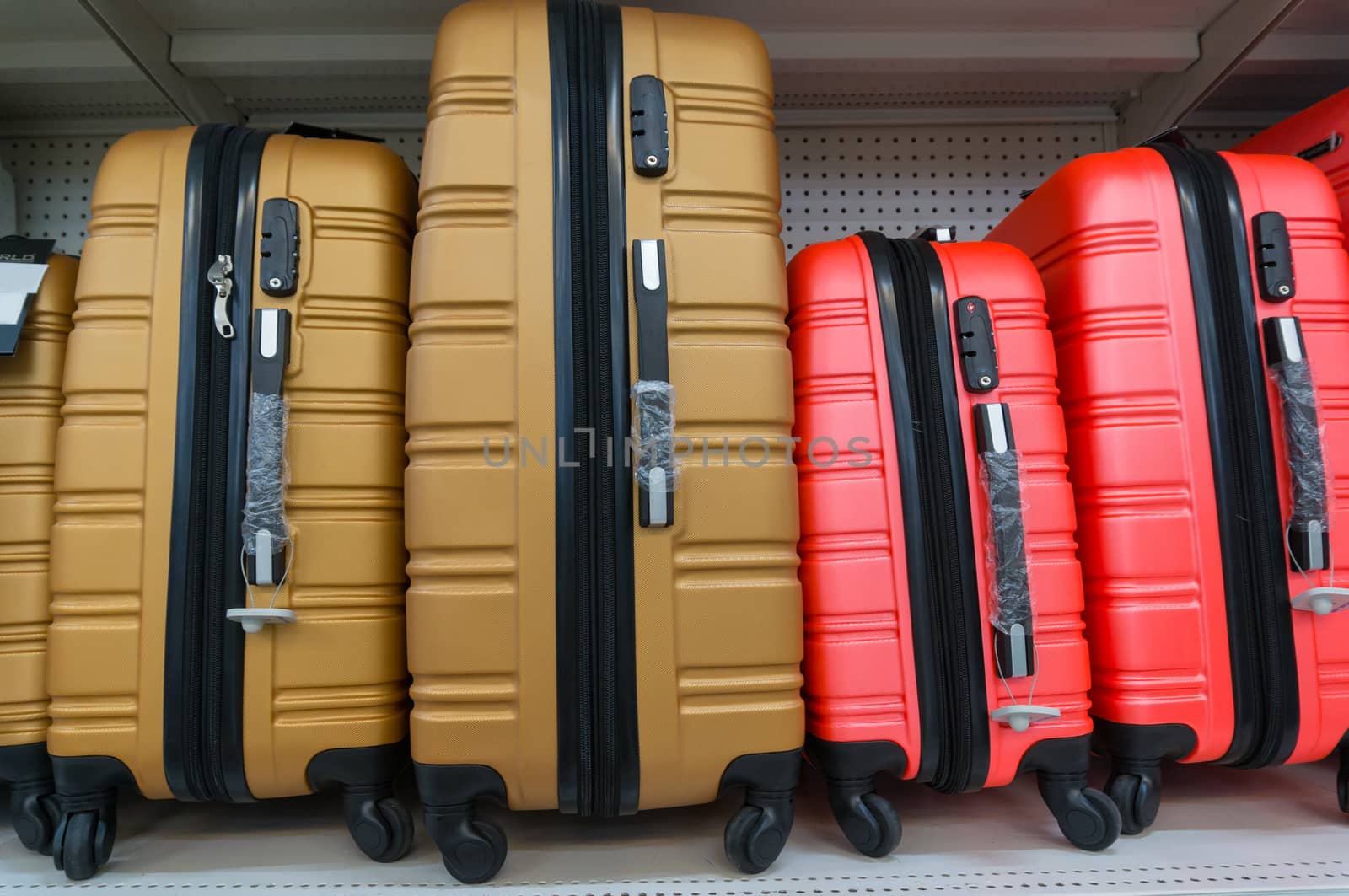 suitcases in a row on shelf by thampapon