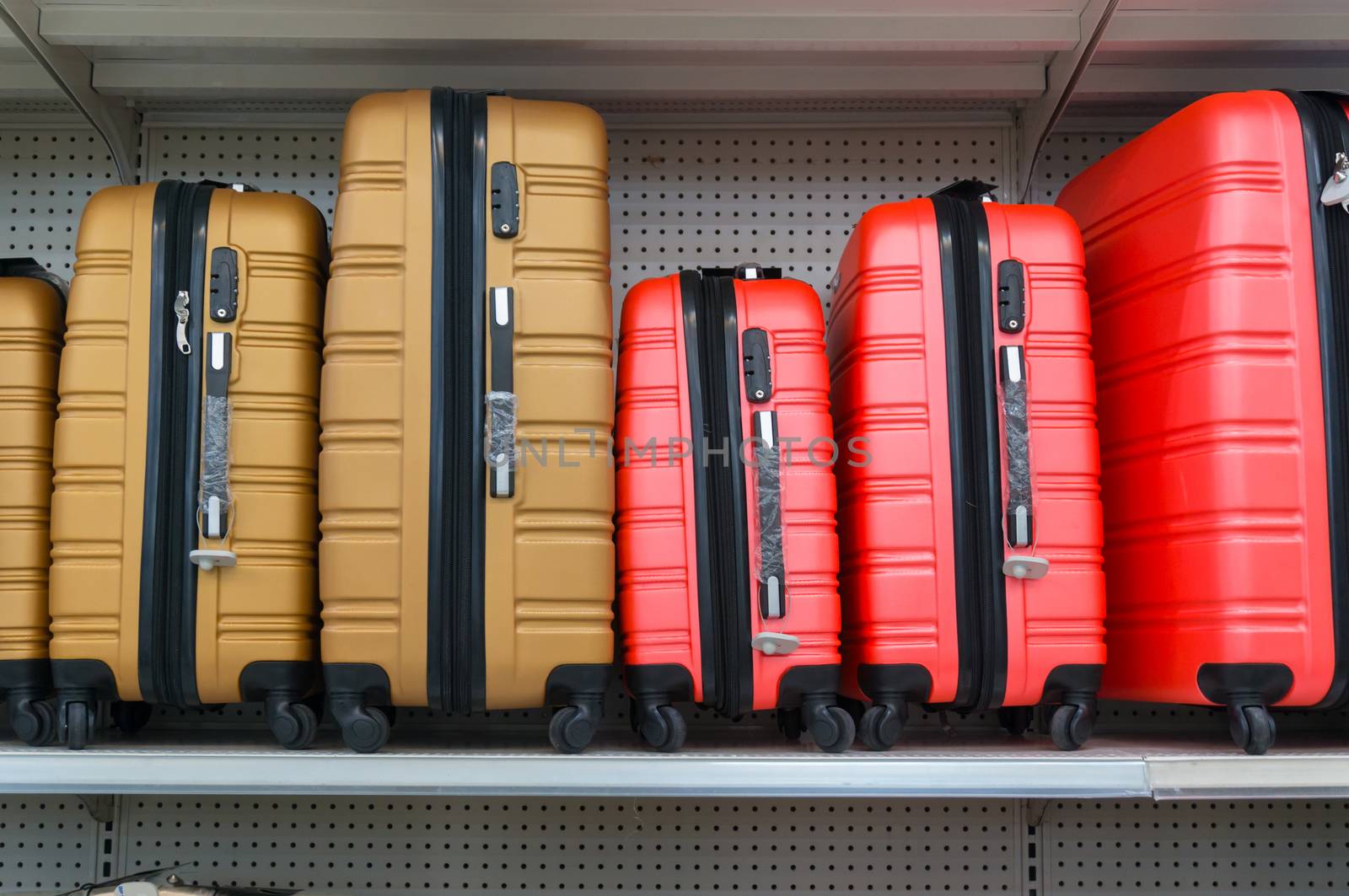 Yellow and Red Suitcases in a Row on Shelf in Supermarket Retail Store outlet