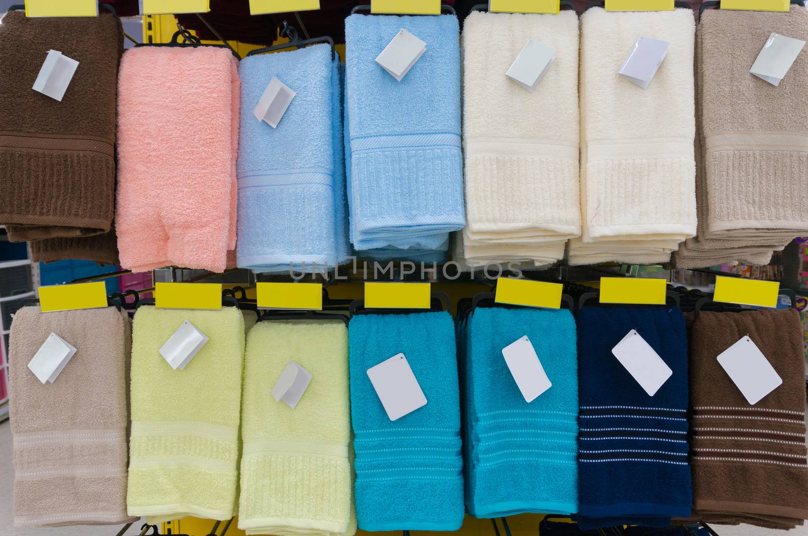 Towels Hang on Shelf in Supermarket or Hypermarket with Blank Ta by thampapon
