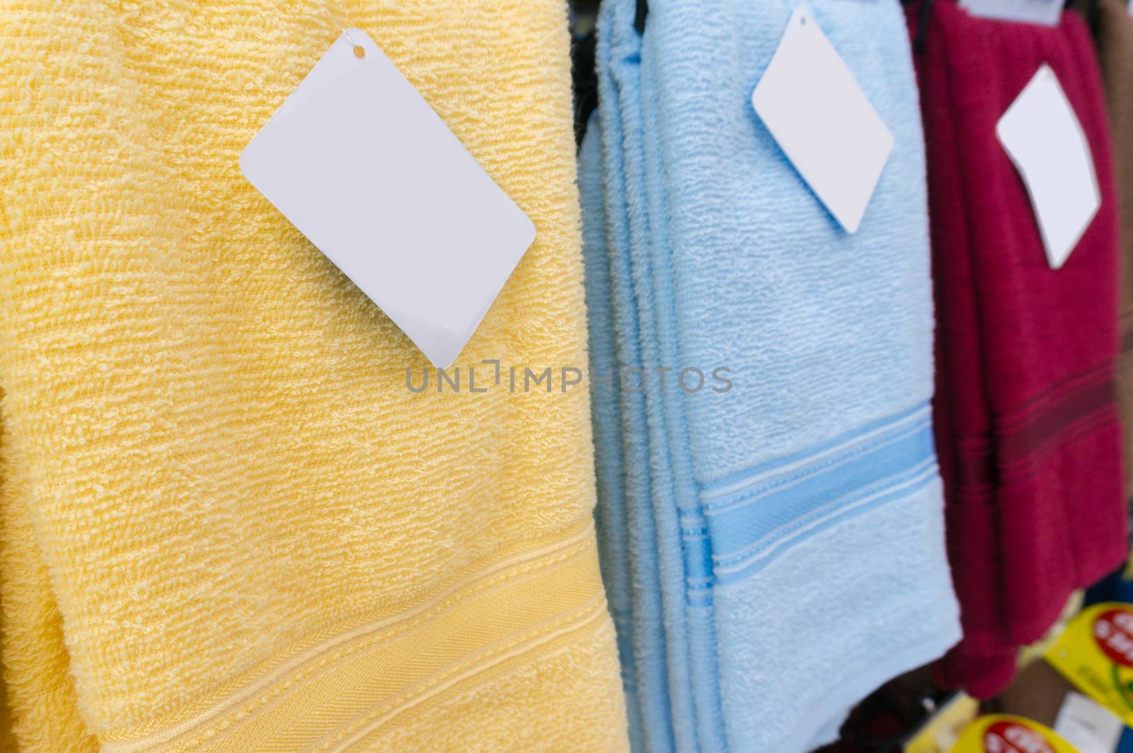 Colorful towels on supermarket shelves with Blank Tags, Shallow Depth of Field