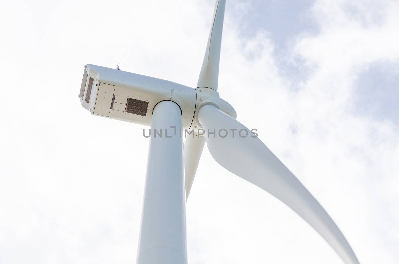 Wind turbine generating electricity in Holland, photographed from below.