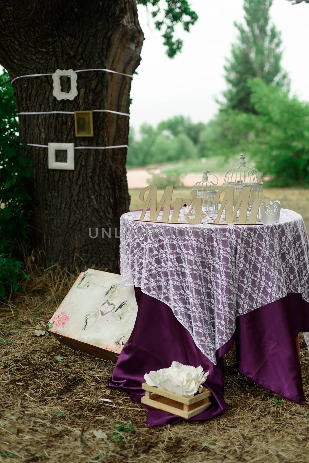 decorative photo zone with a suitcase and a table near the tree