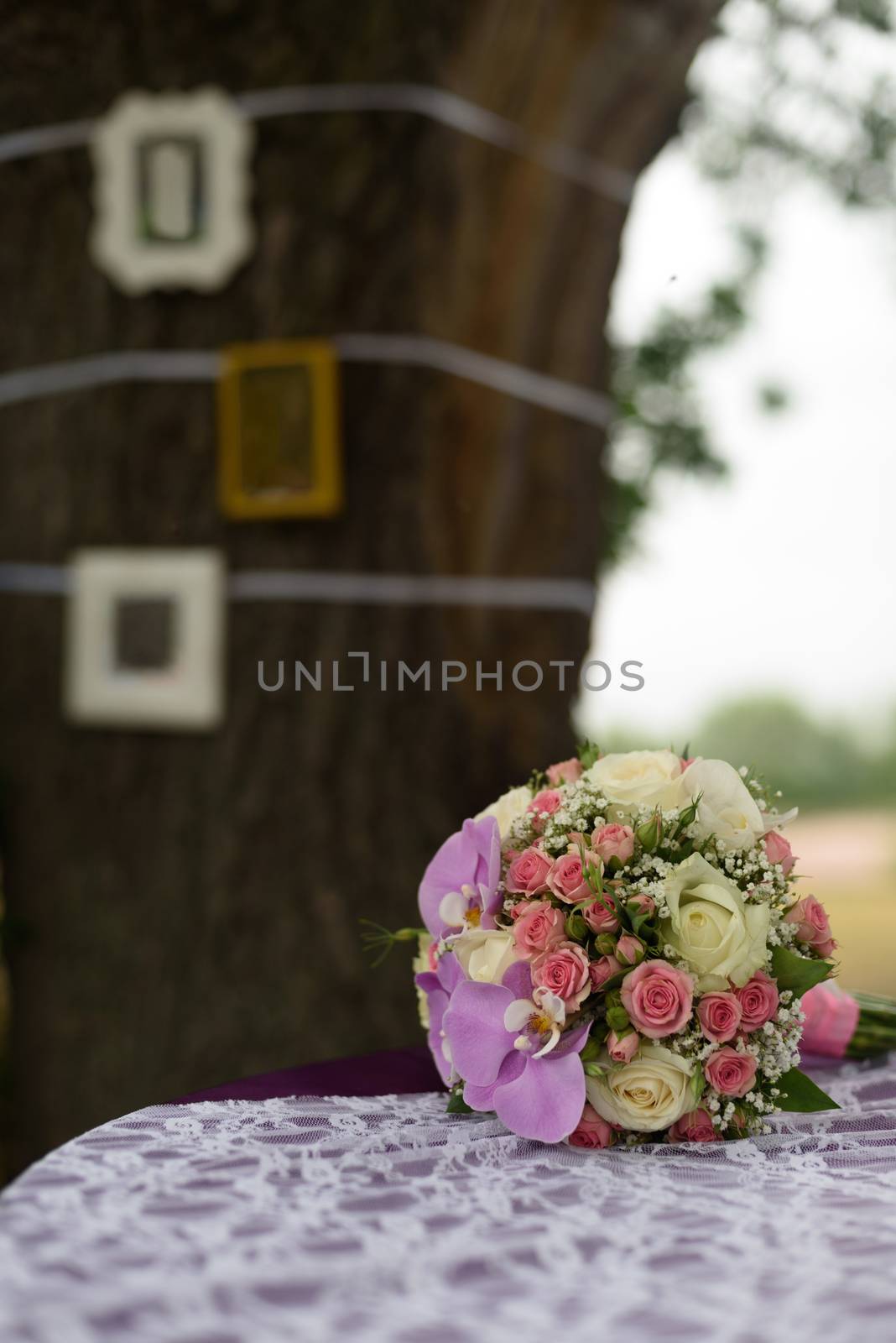 wedding bouquet of roses and orchids is on the table