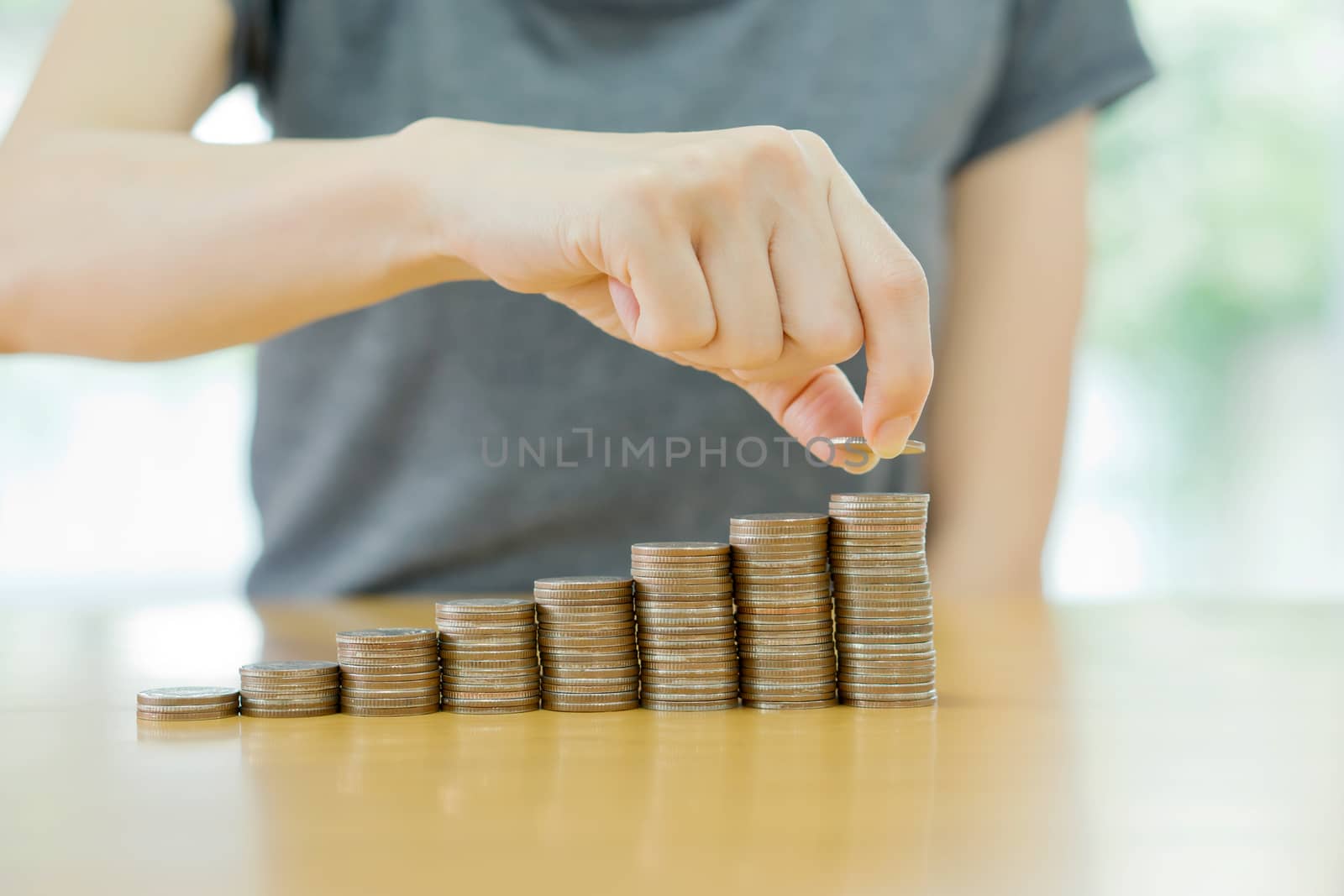 women put coin stack money for money growth concept