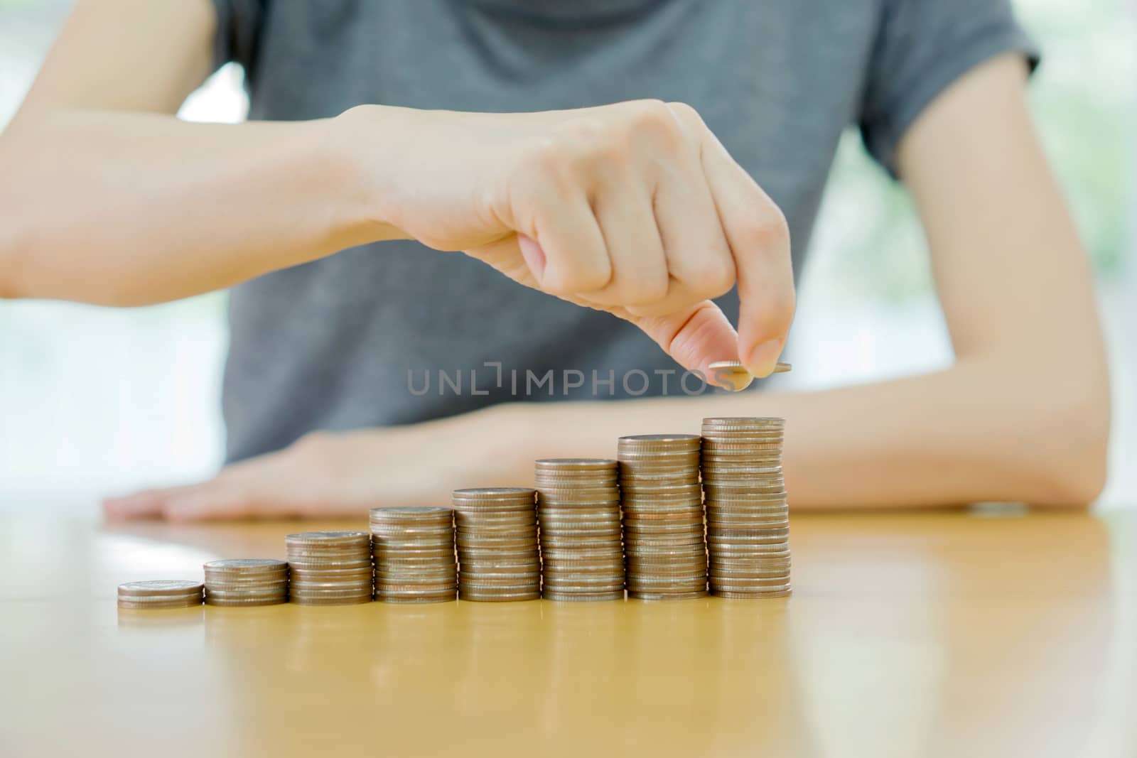 women put coin stack money for money growth concept