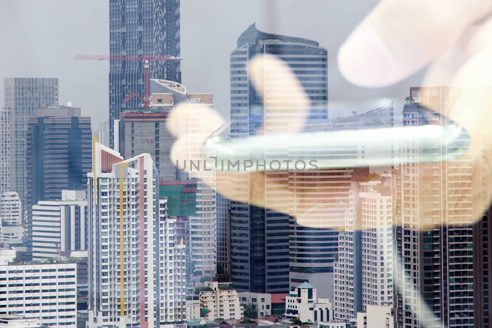 Double exposure image of people with smart phone and cityscape background,communication technology concept.