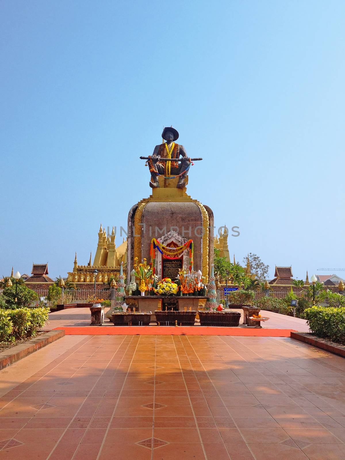 Exterior of the statue of the King Chao Anouvong in front of the Pha That Luang stupa in Vientiane, Laos.