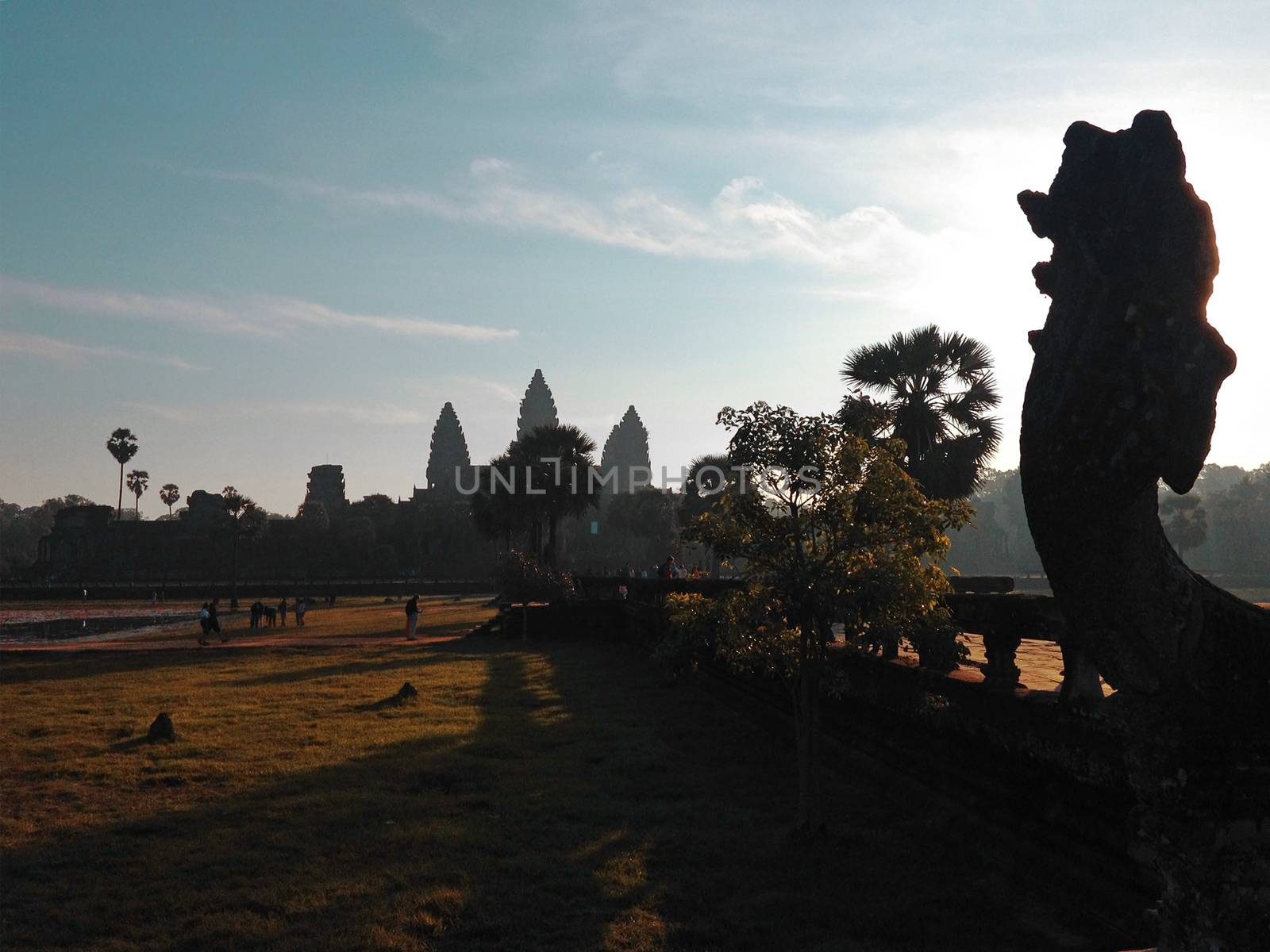 A beautiful morning sunrise shows Angkor Temple as silhouette on the entrance walkway to the Angkor Wat Complex in Siem Reap, Cambodia