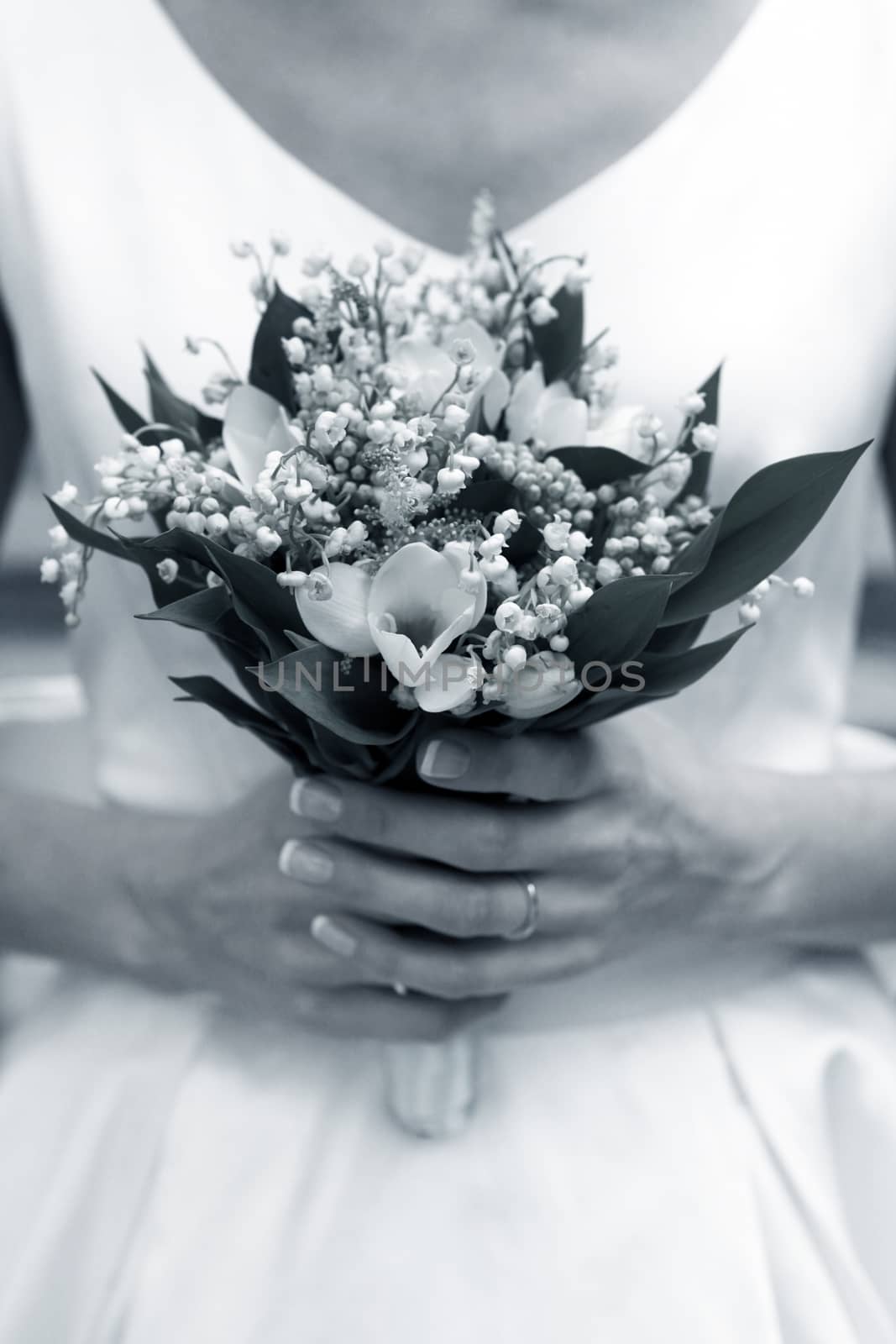 The bride holds a wedding bouquet