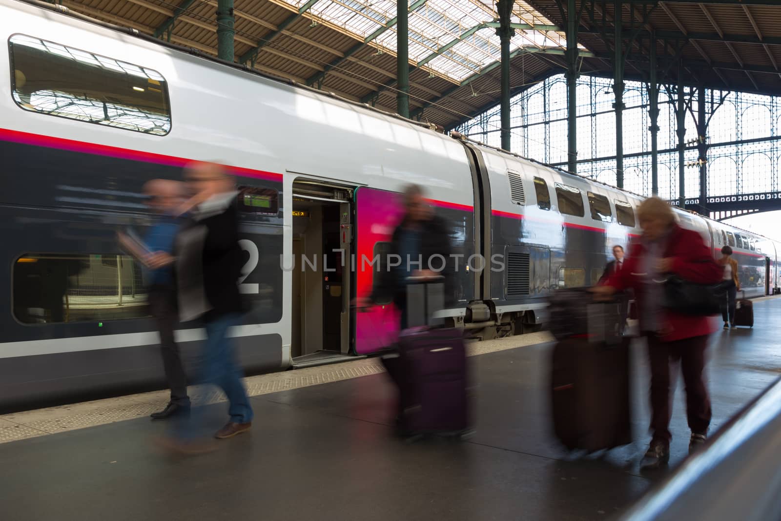 Subway train at the station. People coming to or leaving train station platform. Motion blur. City life.