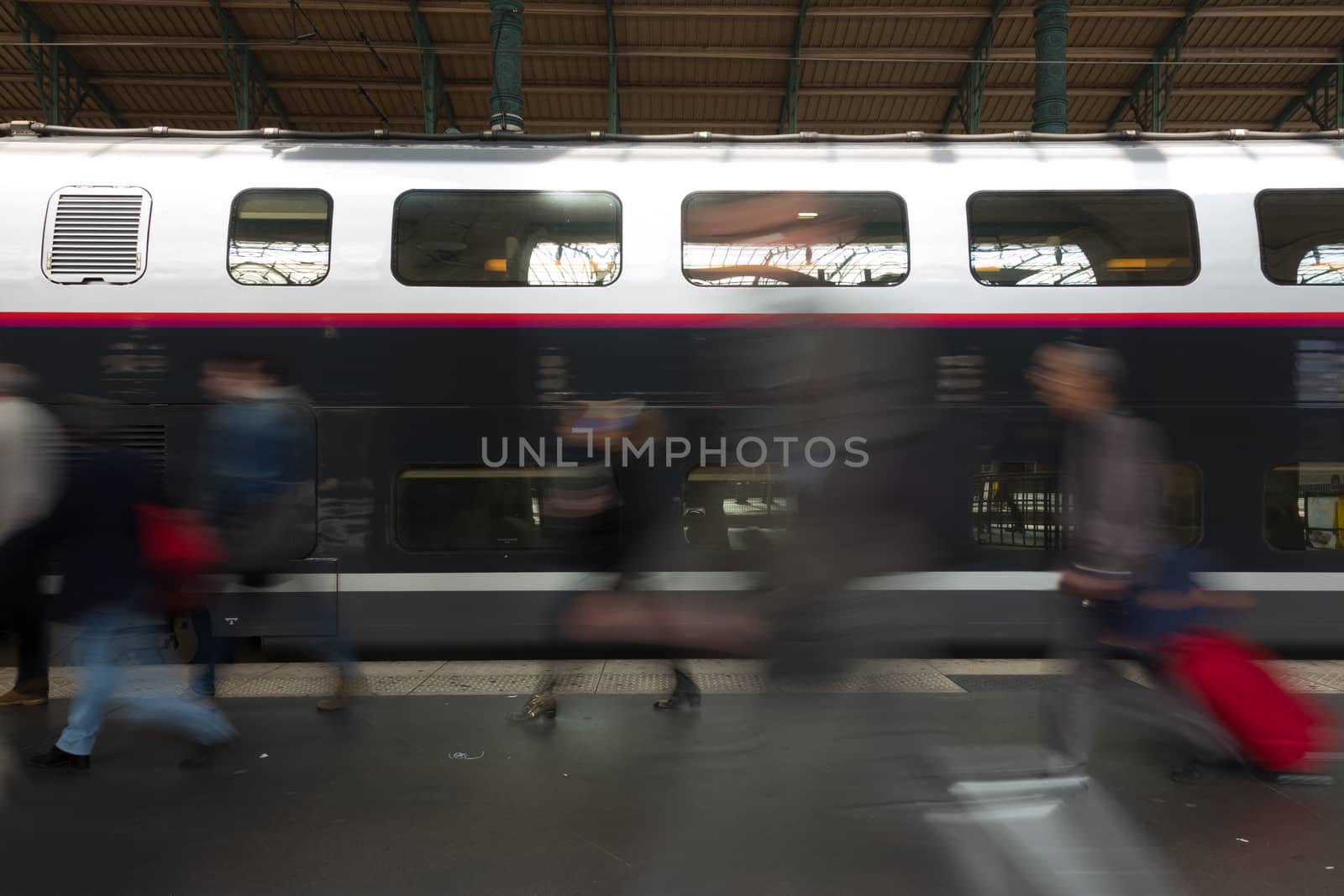 Subway train at the station. People coming to or leaving train station platform. Motion blur. City life.