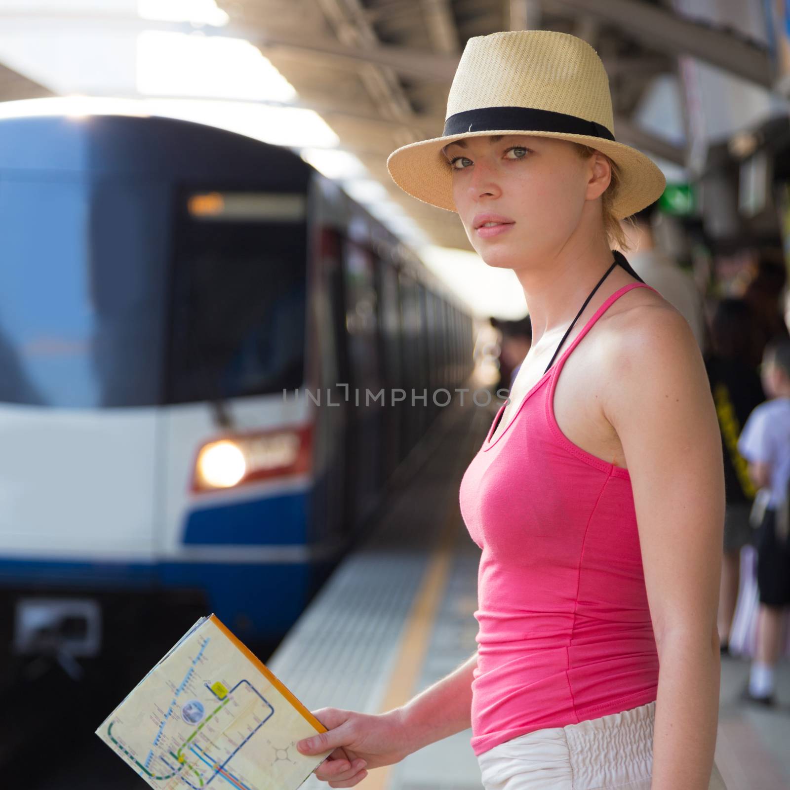 Young woman on platform of railway station. by kasto