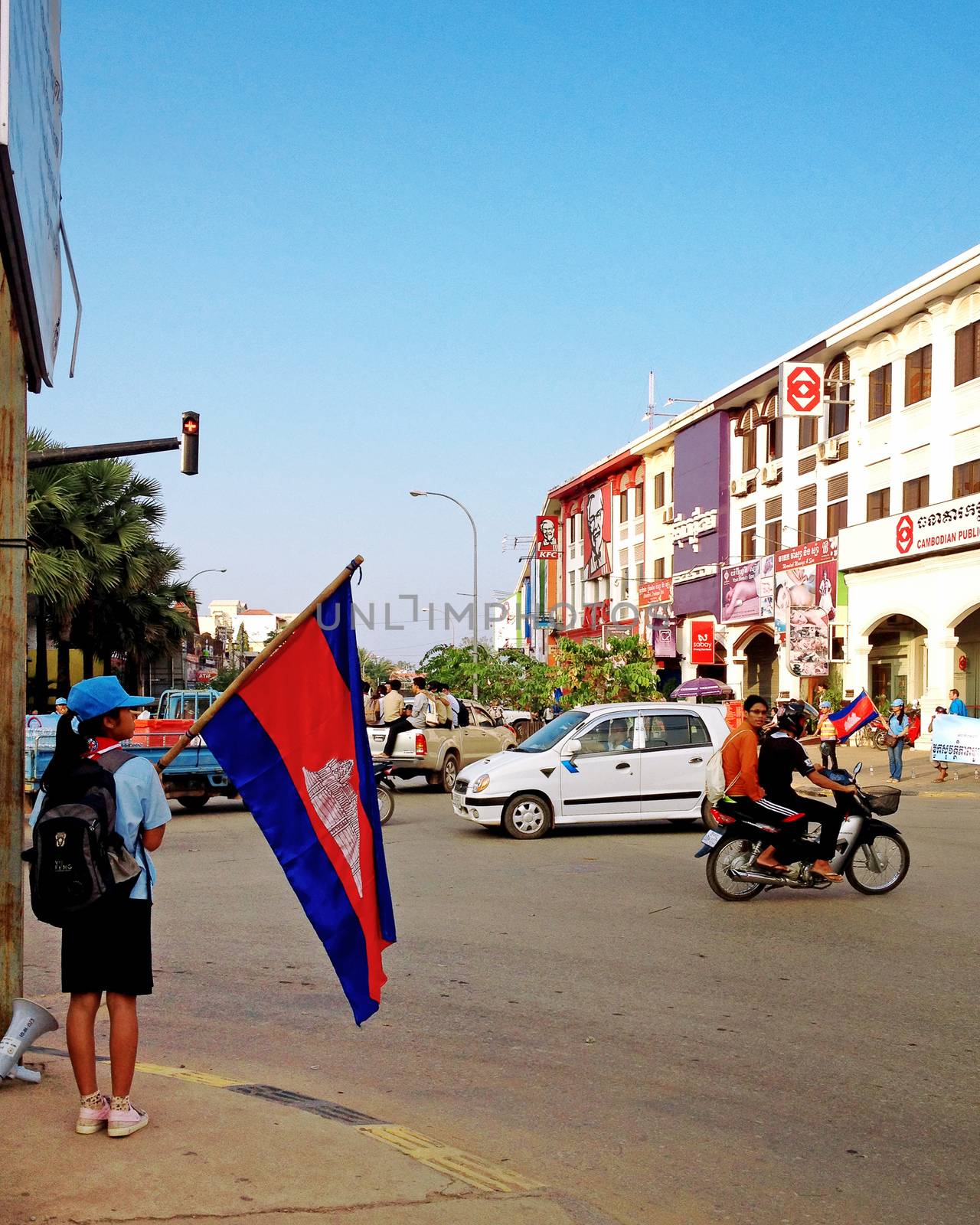  SIEM REAP, CAMBODIA - December 22, 2013 : Cambodian student with national flag at city street in Siem Reap, Cambodia