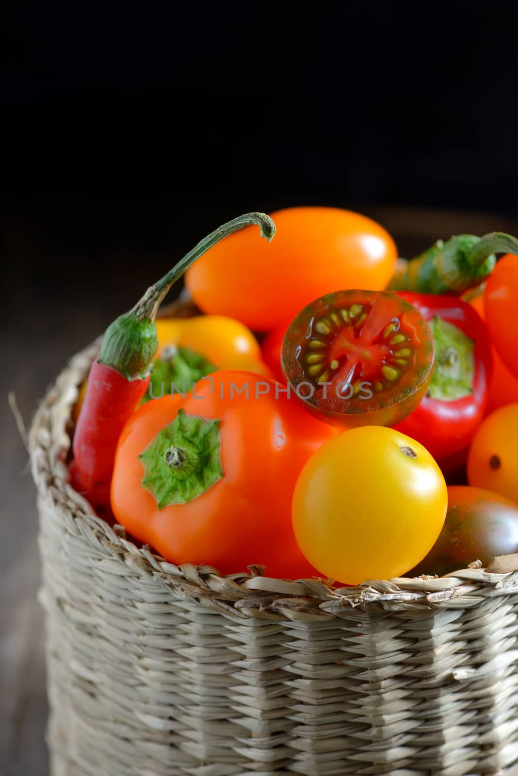 Fresh ripe colorful vegetables tomatoes in basket