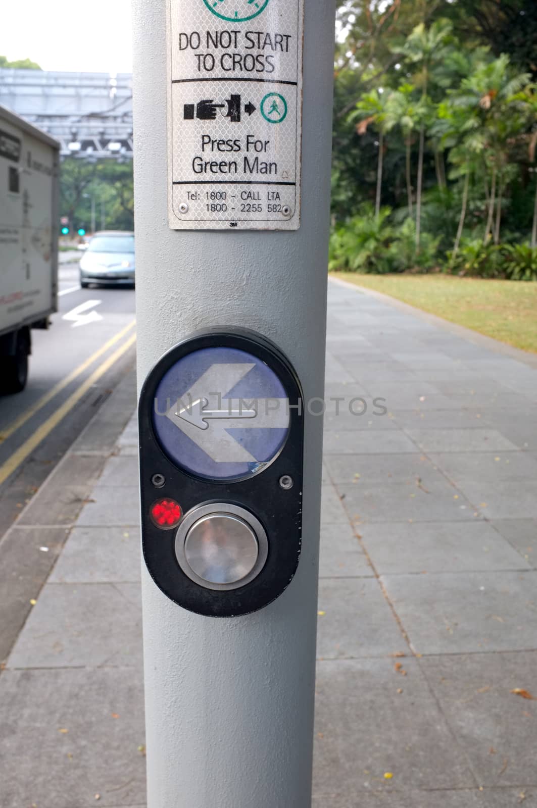 Arrow and button to press for Pedestrian Crossing