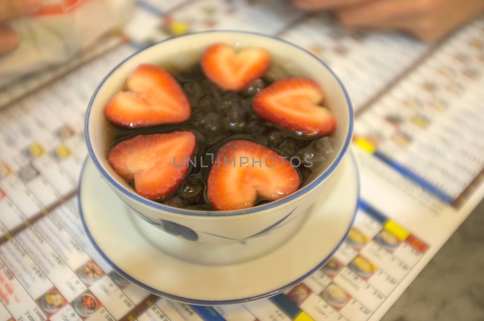 Grass jelly and strawberry with ice in dessert bowl