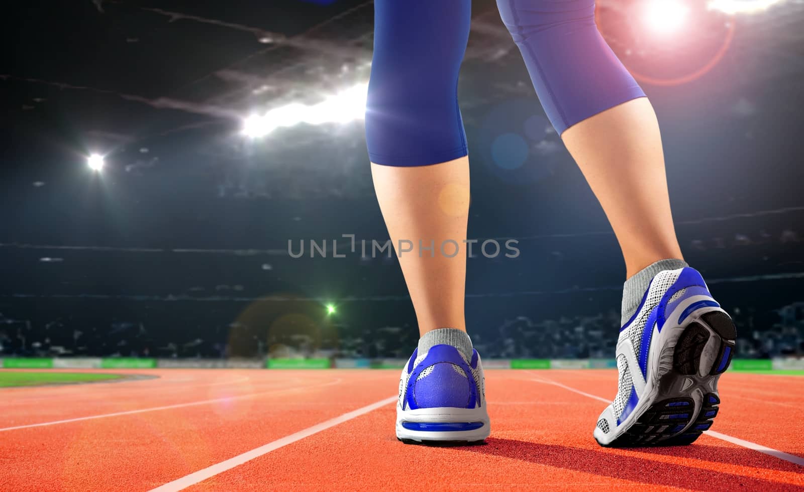 Legs of athlete on running track in the stadium