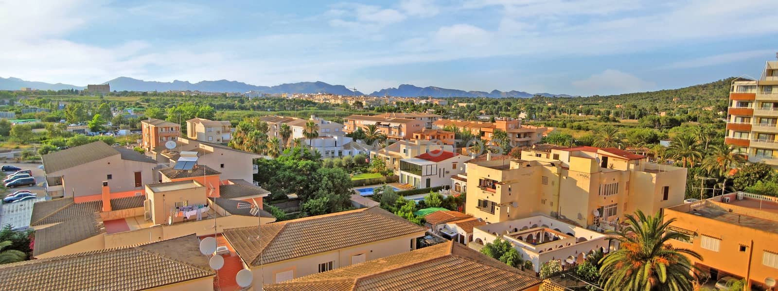 Alcudia, Majorca, Spain - June 27, 2008: Panorama view over residential buildings / homes city of Alcudia towards Tramuntana mountains, north of Majorca