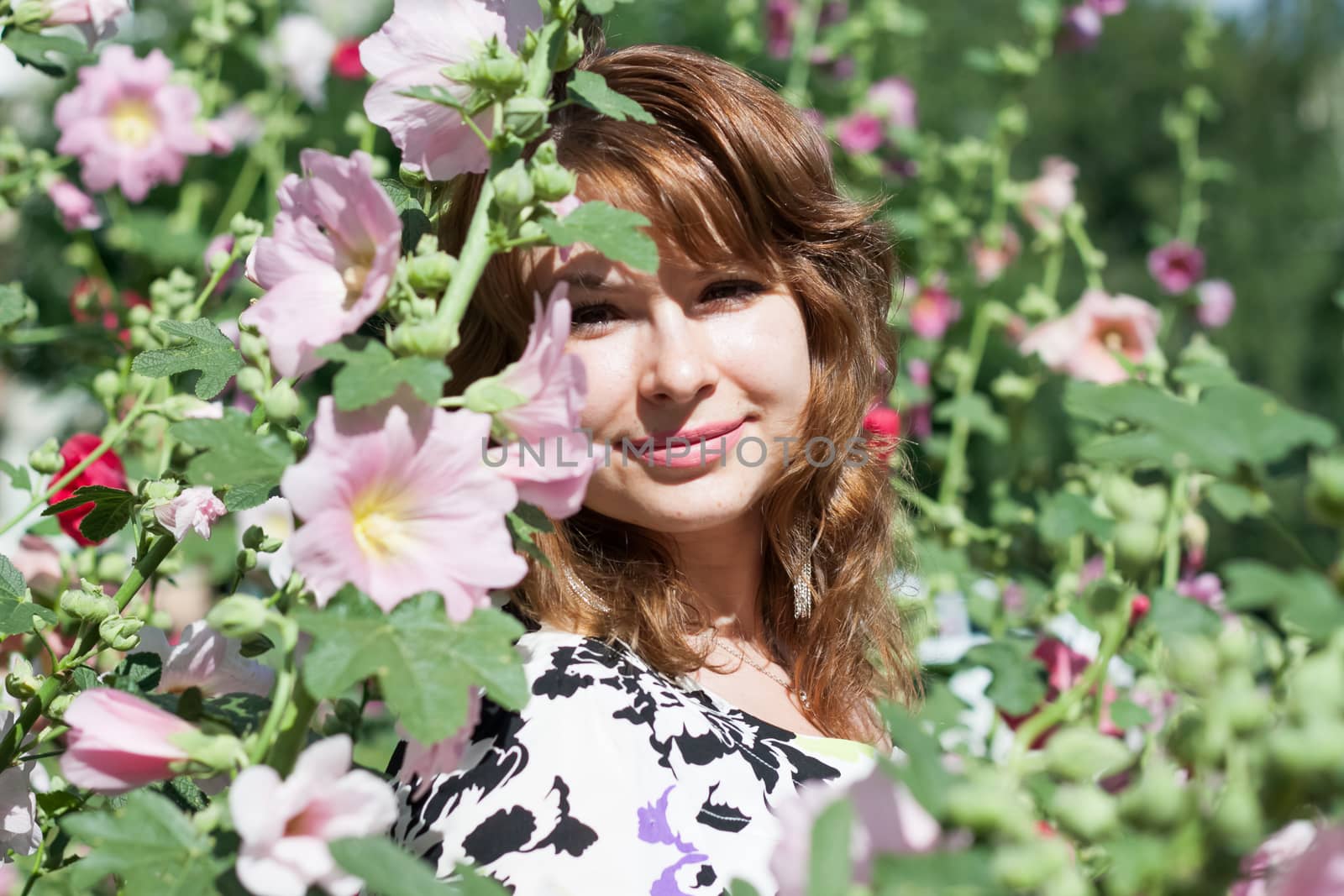 beautiful women surrounded by colorful flowers mallow