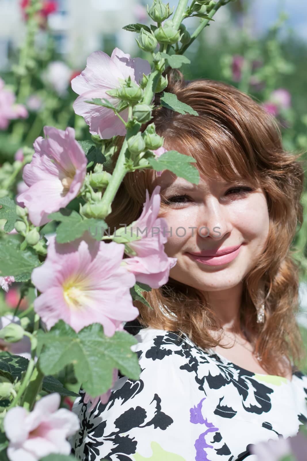 beautiful women surrounded by colorful flowers mallow