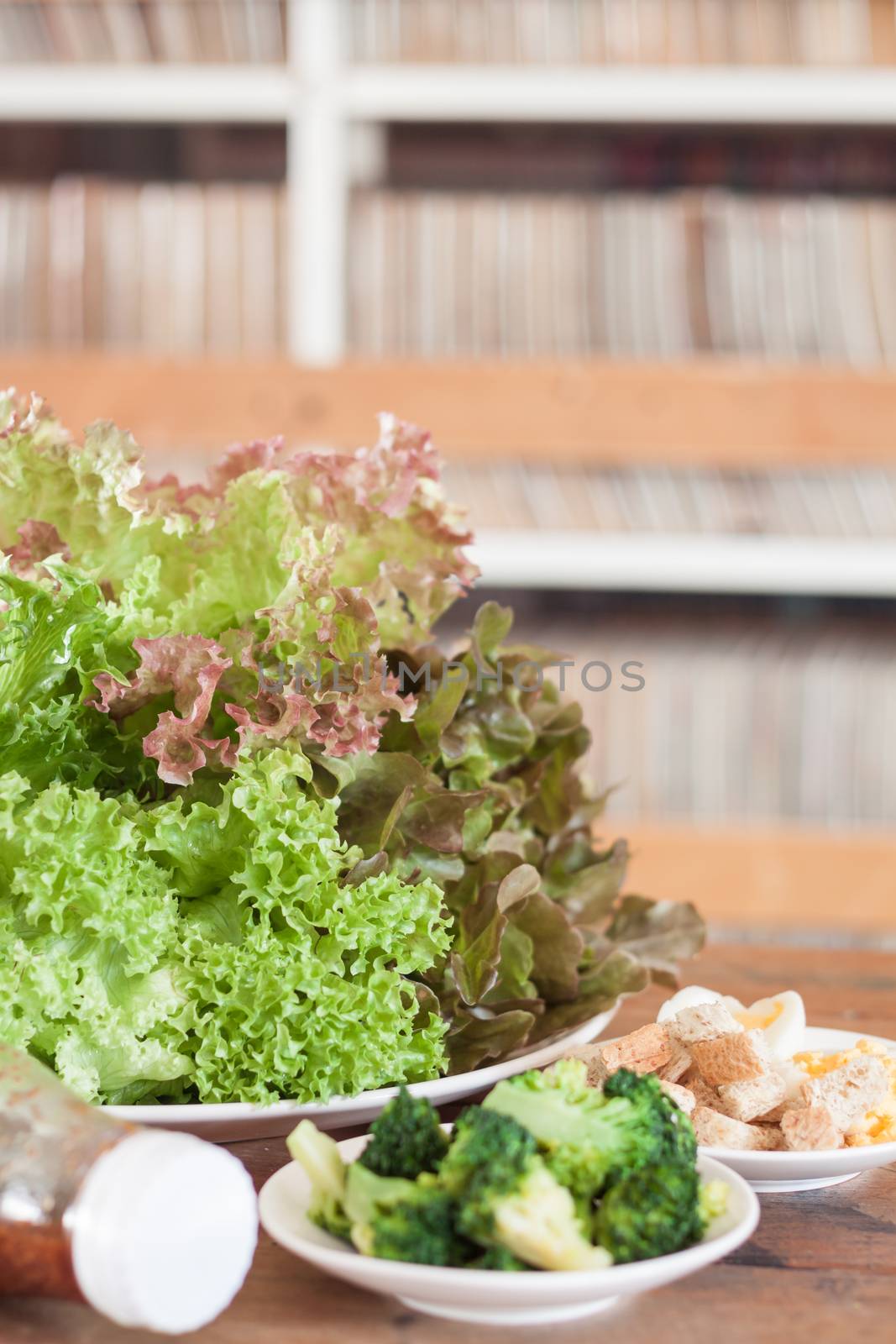 Fresh hydroponic vegetables on wooden table by punsayaporn