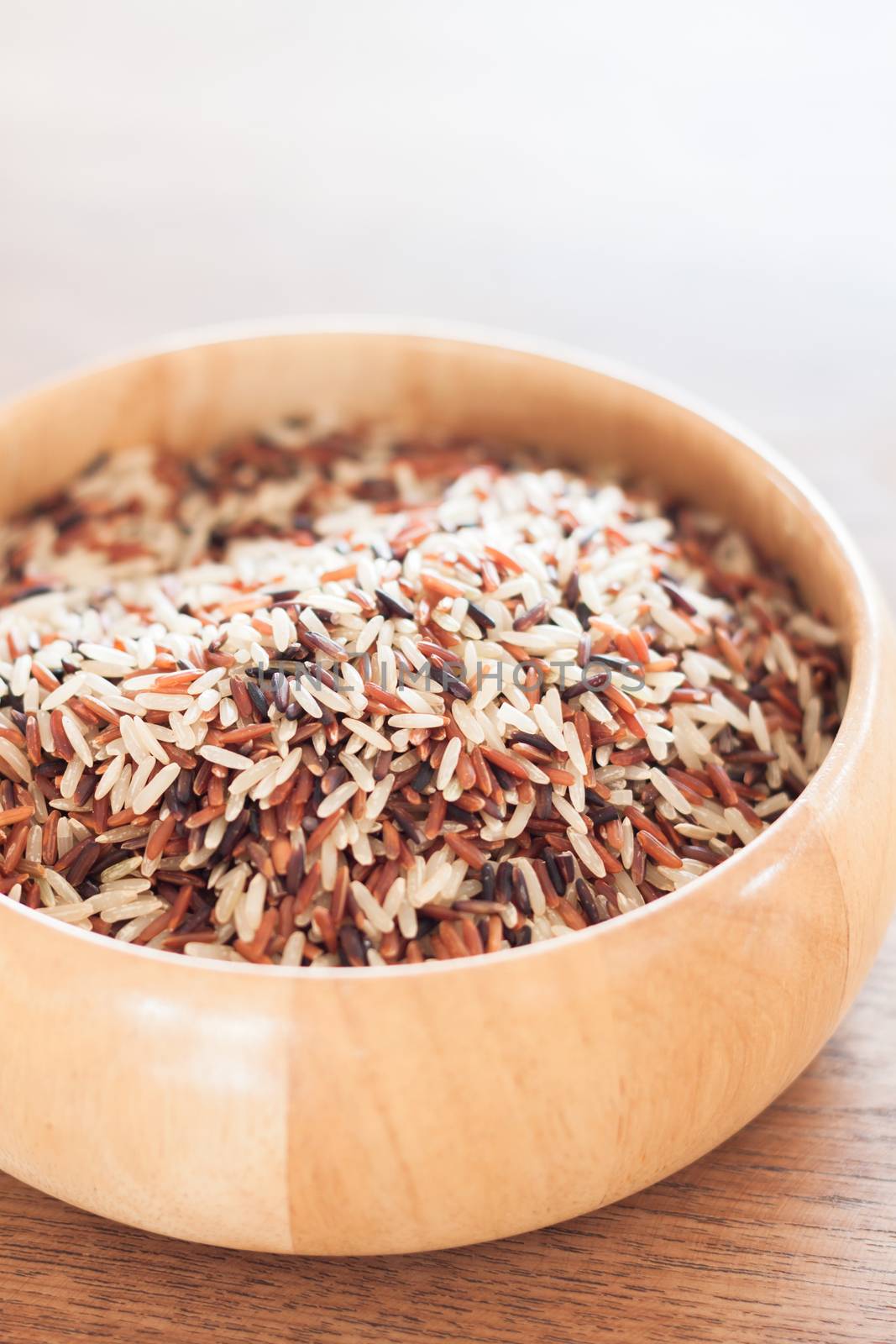 Organic Dry Multi Grain Rice in wooden bowl, stock photo