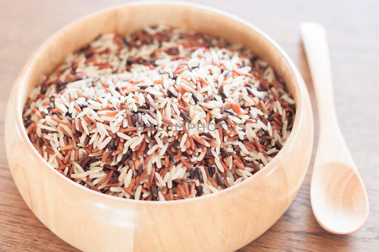 Organic Dry Multi Grain Rice in wooden bowl, stock photo