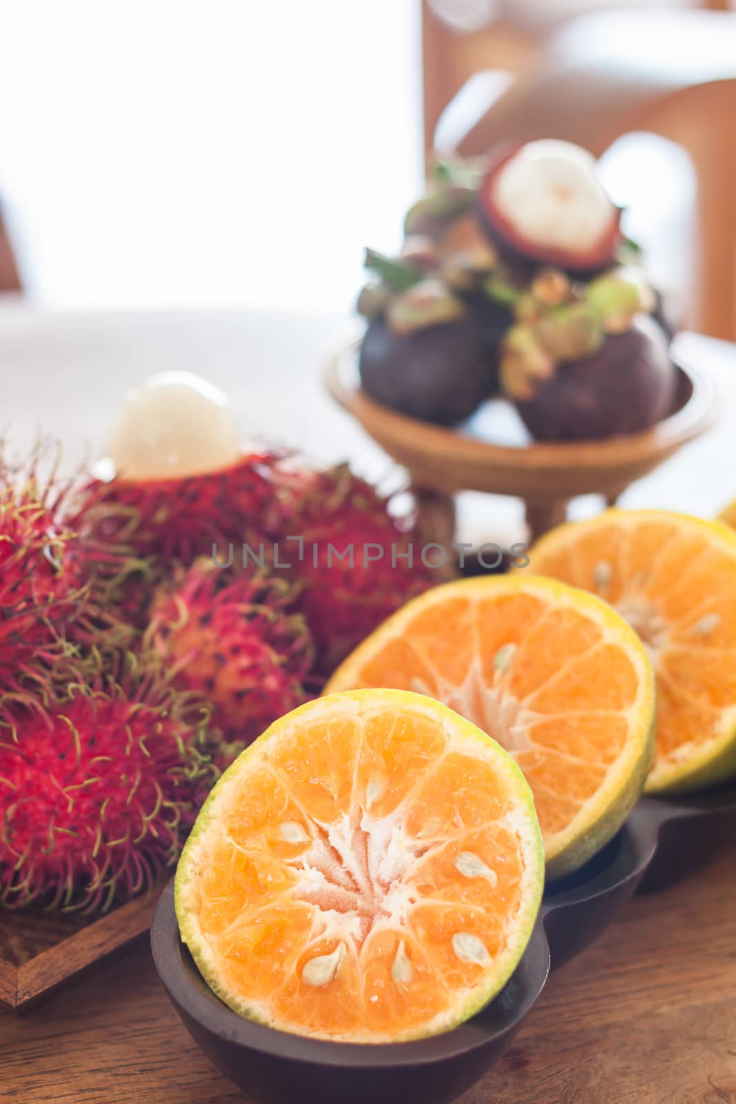 Thai tropical fruit on wooden table by punsayaporn