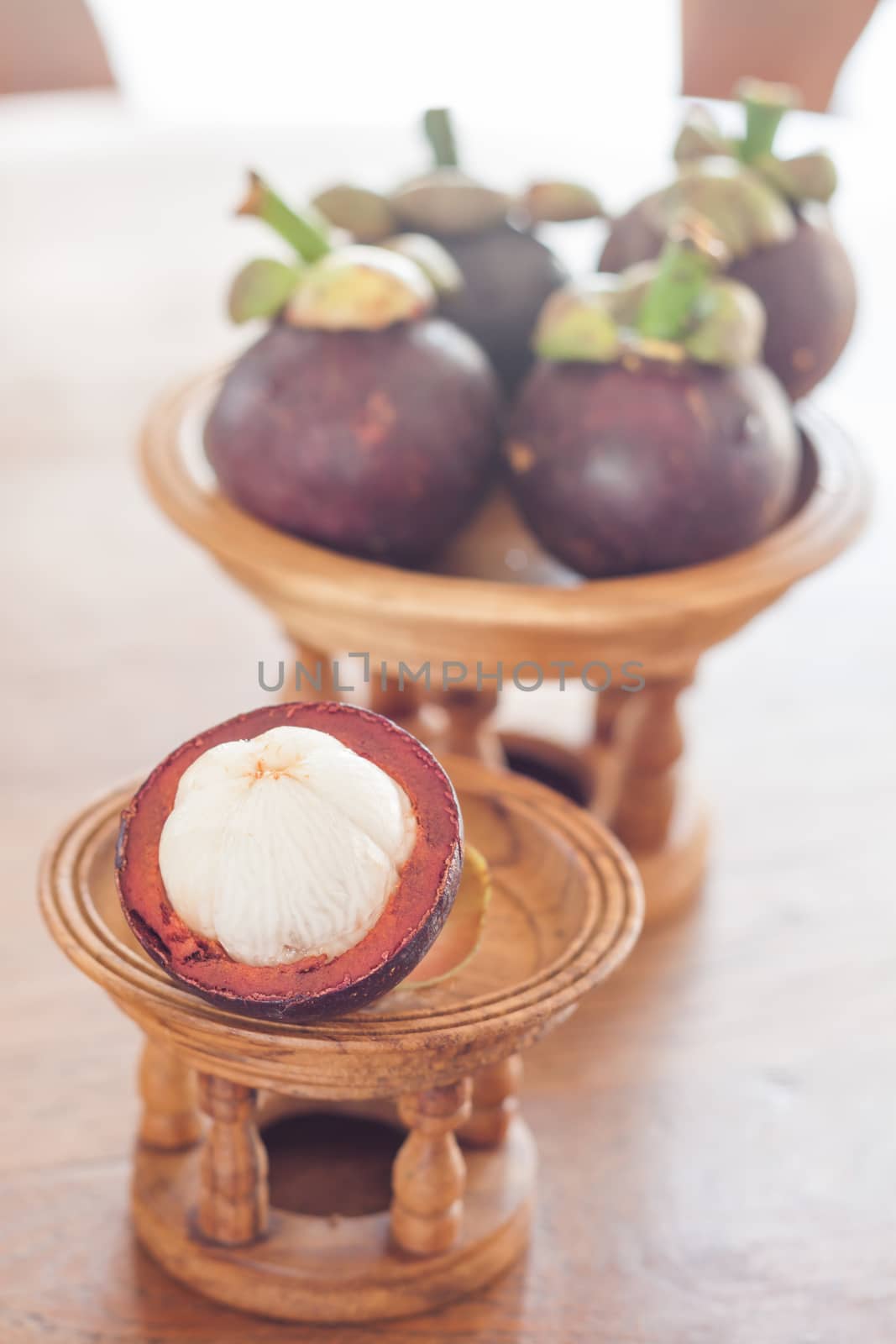 Group of mangoesteen on wooden tray  by punsayaporn