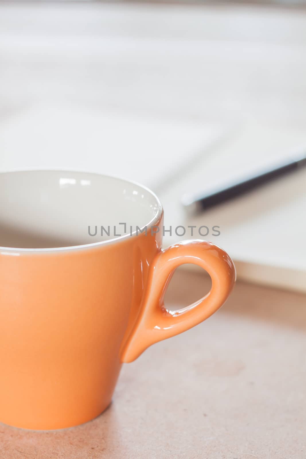 Pen and spiral notebook with coffee cup, stock photo