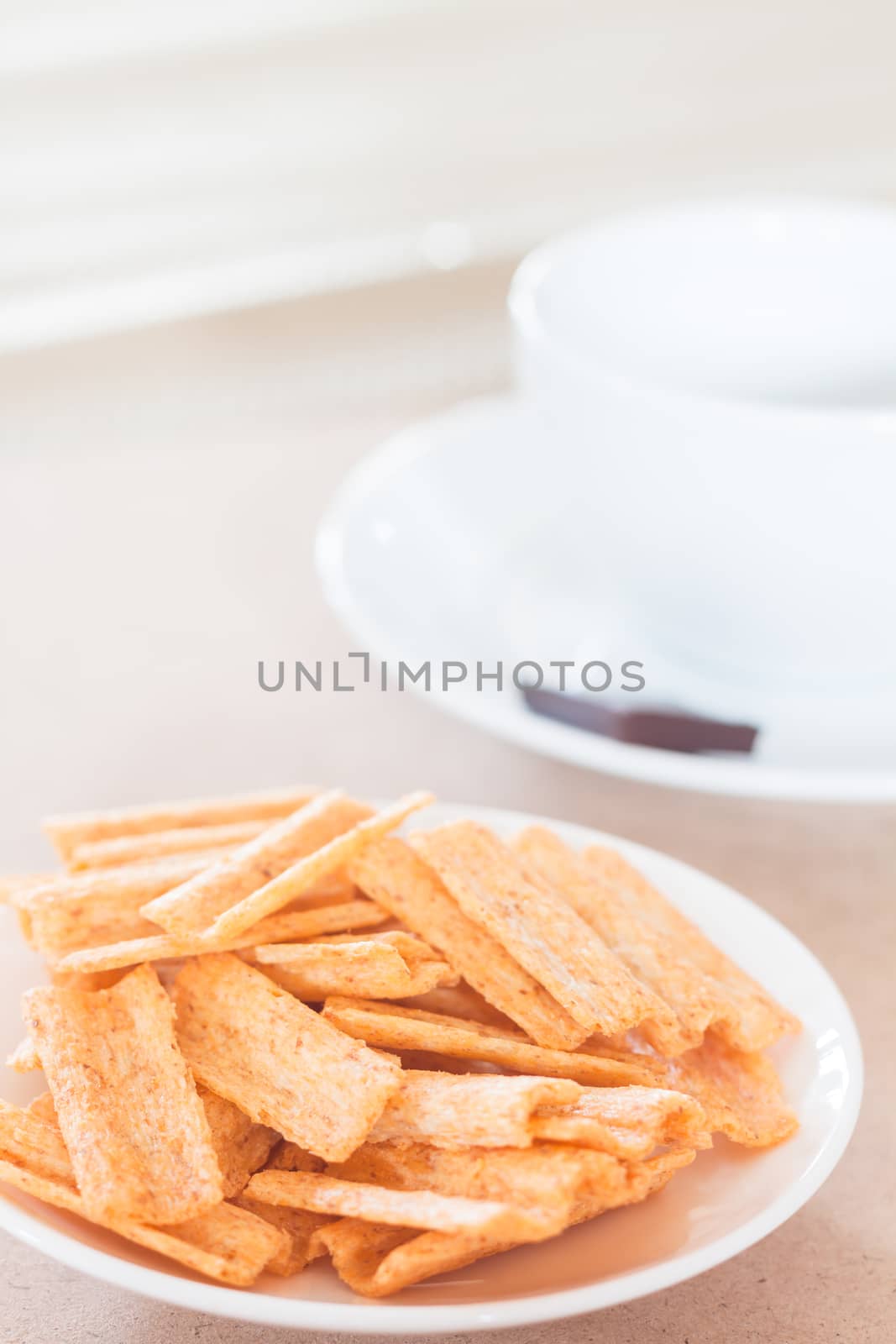 Snack on white plate with coffee cup, stock photo