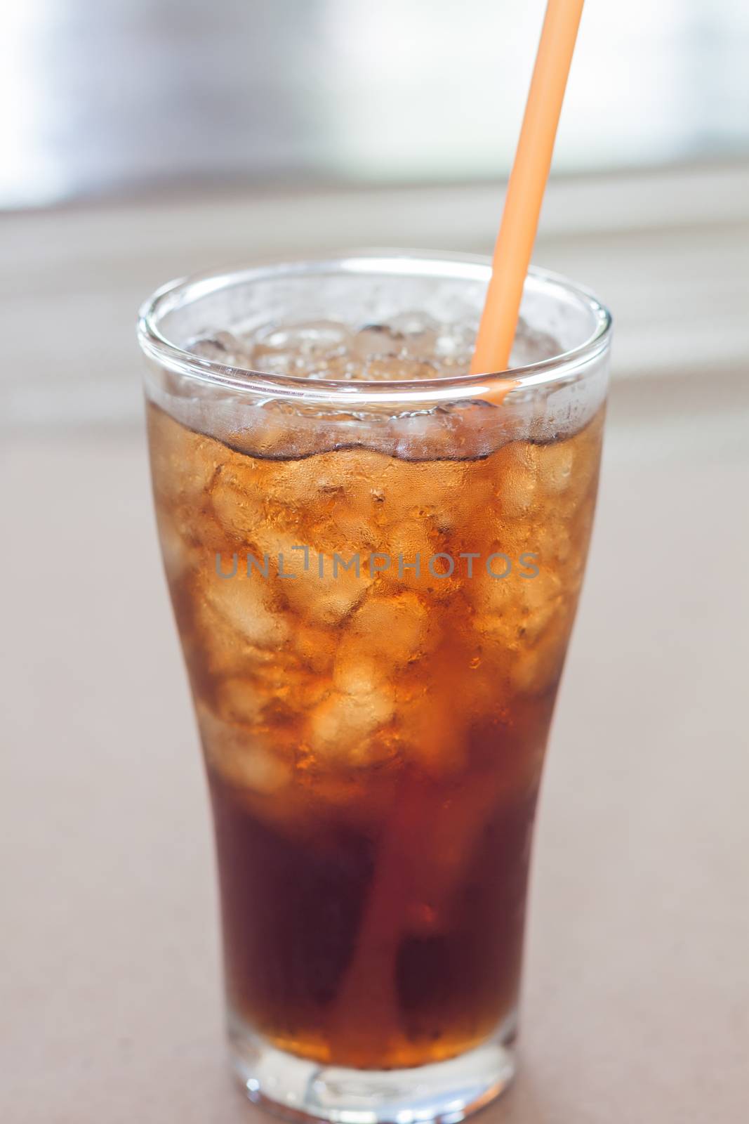 A glass of cola with ice by punsayaporn