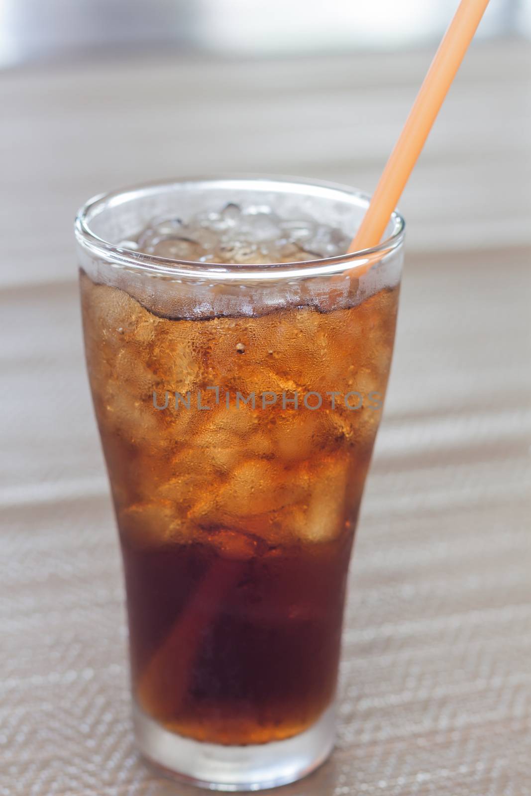 A glass of cola with ice by punsayaporn