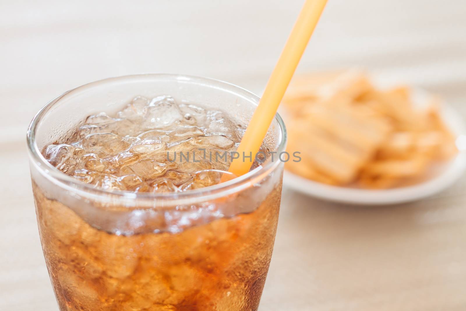 A glass of cola with snack on white plate , stock photo