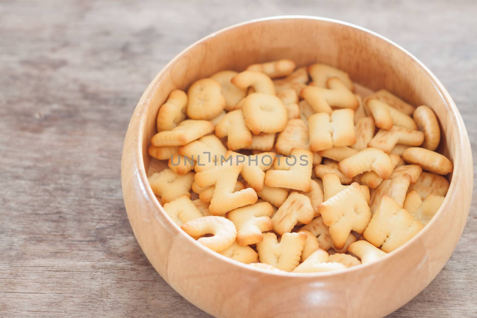 Alphabet biscuit in wooden tray, stock photo