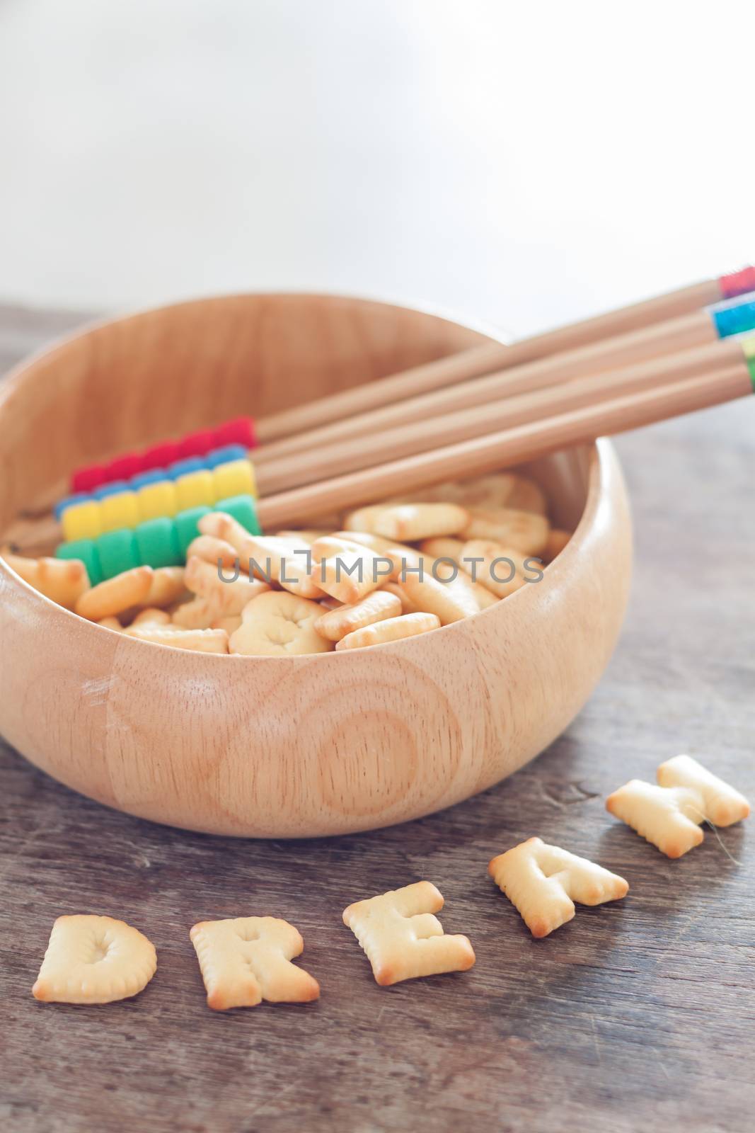 Dream alphabet biscuit on wooden table, stock photo