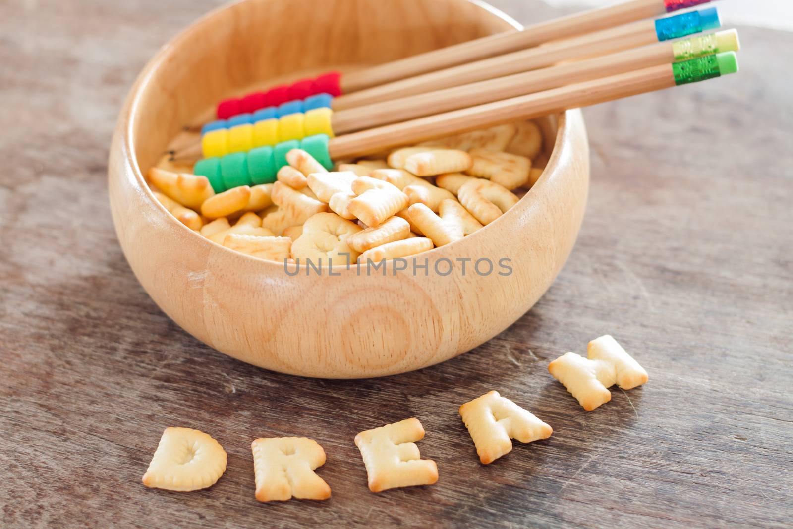 Dream alphabet biscuit on wooden table, stock photo