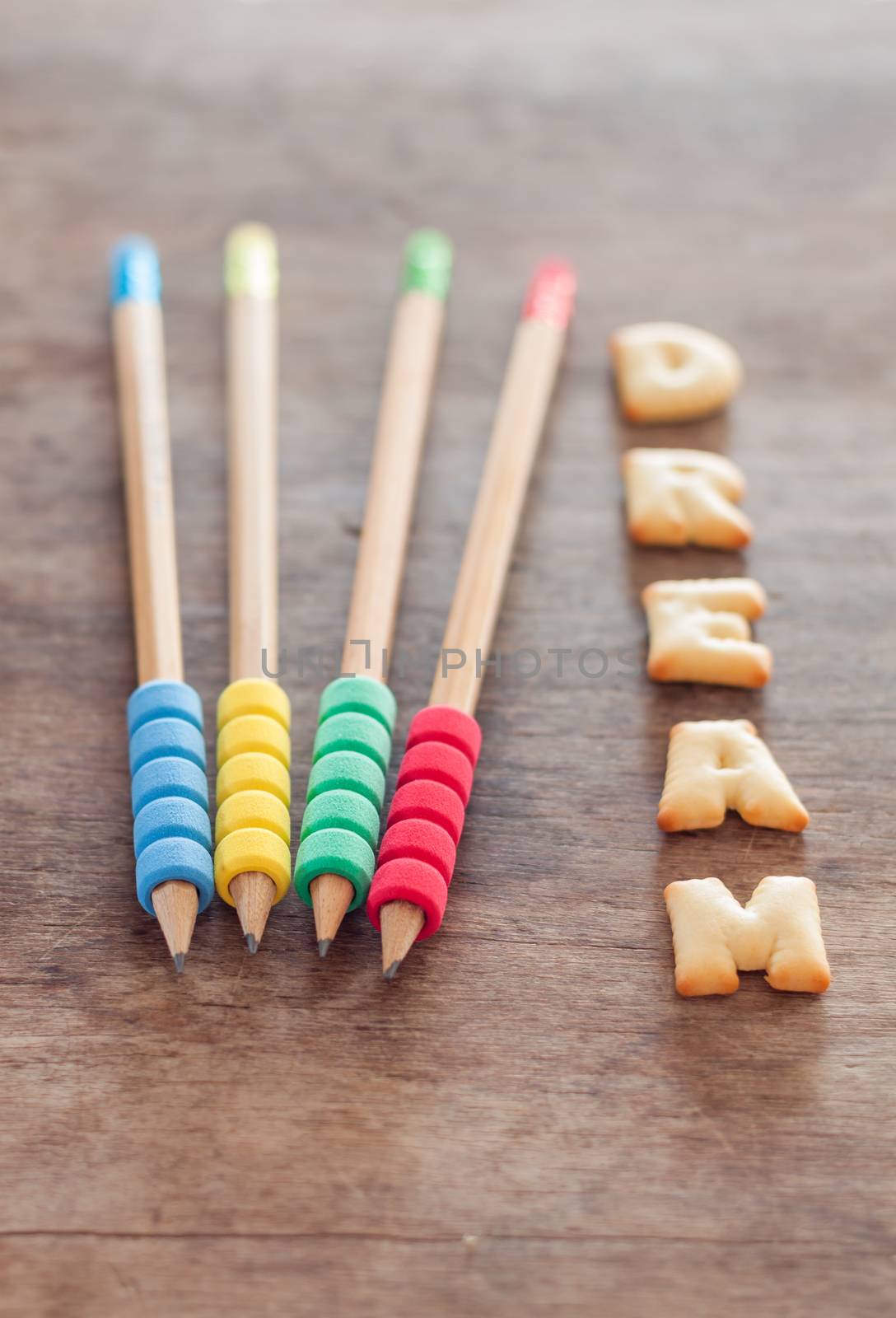 Dream alphabet biscuit on wooden table, stock photo