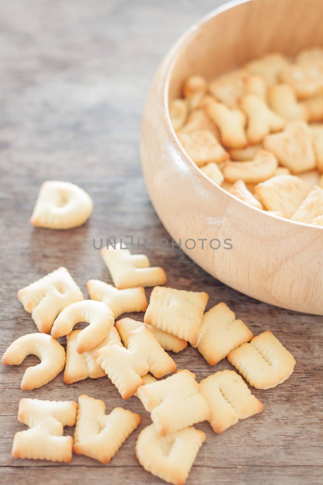 Alphabet biscuit in wooden tray, stock photo