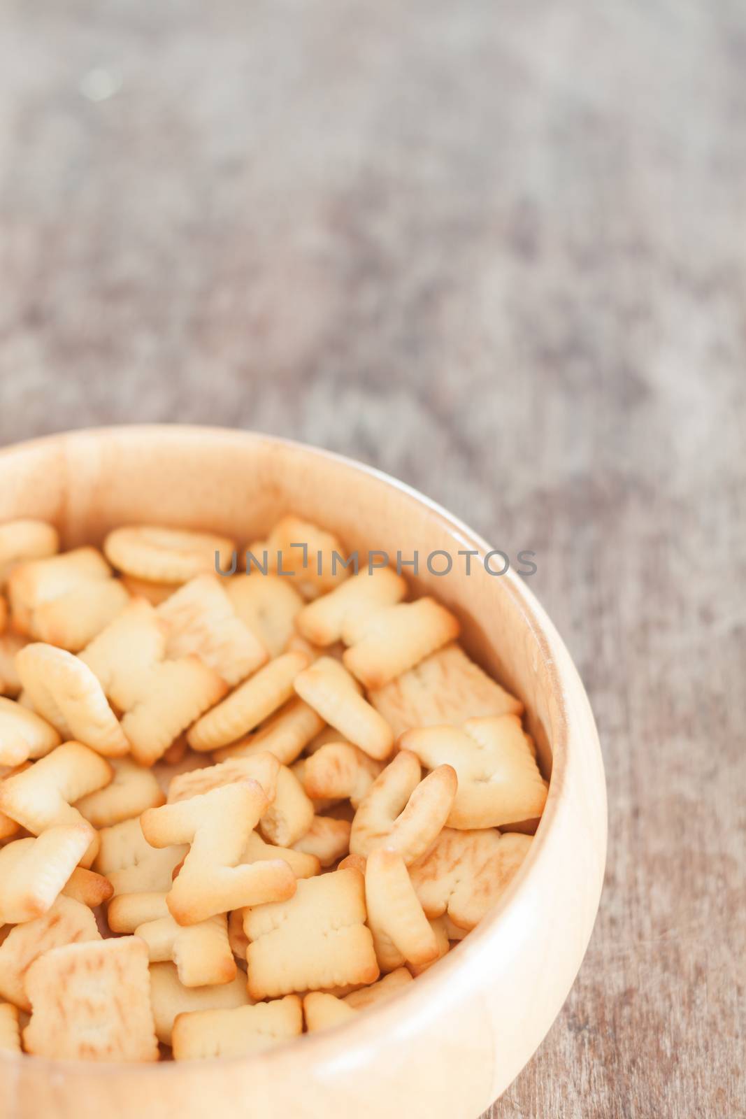 Alphabet biscuit in wooden tray, stock photo