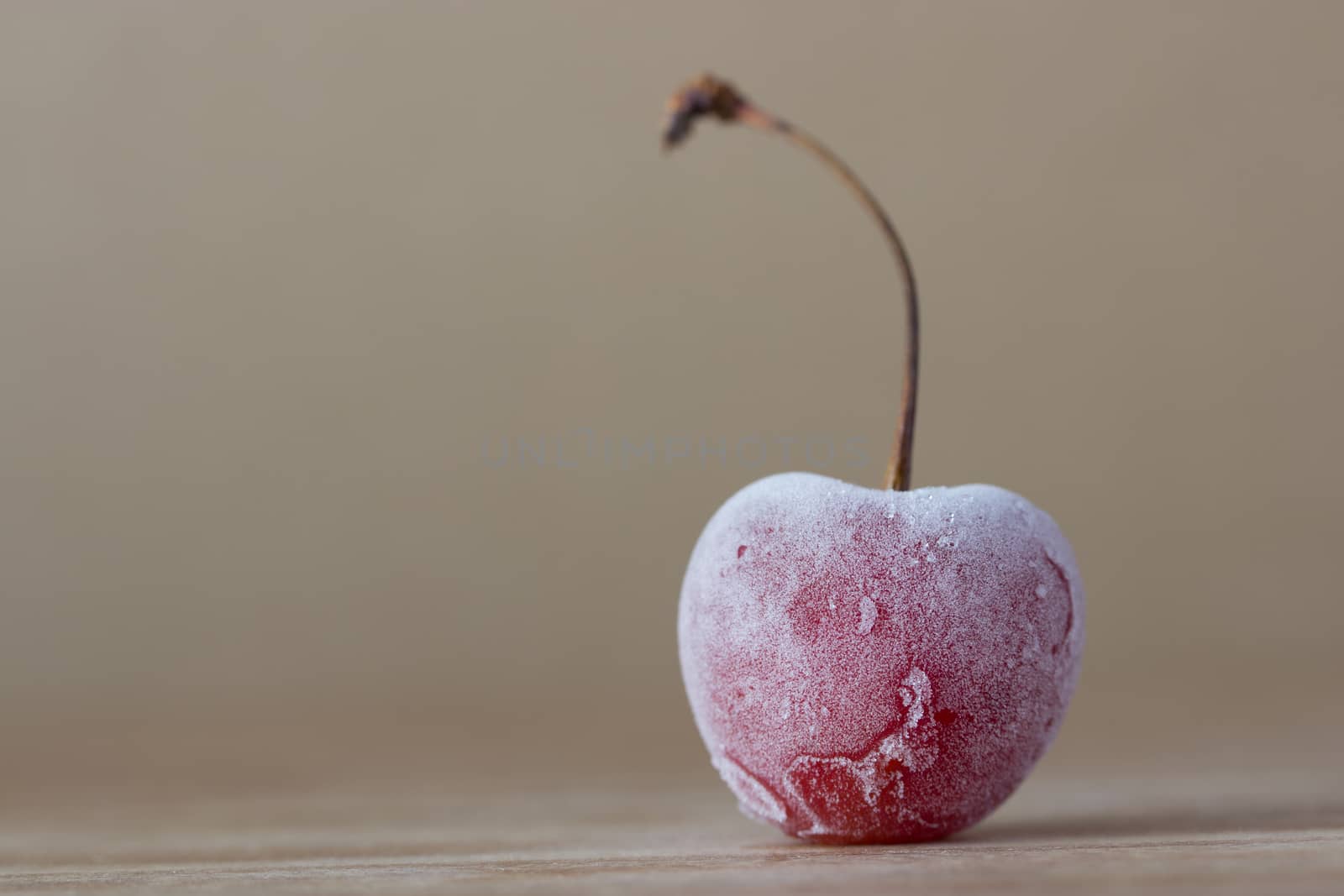 one frozen cherry on wooden background