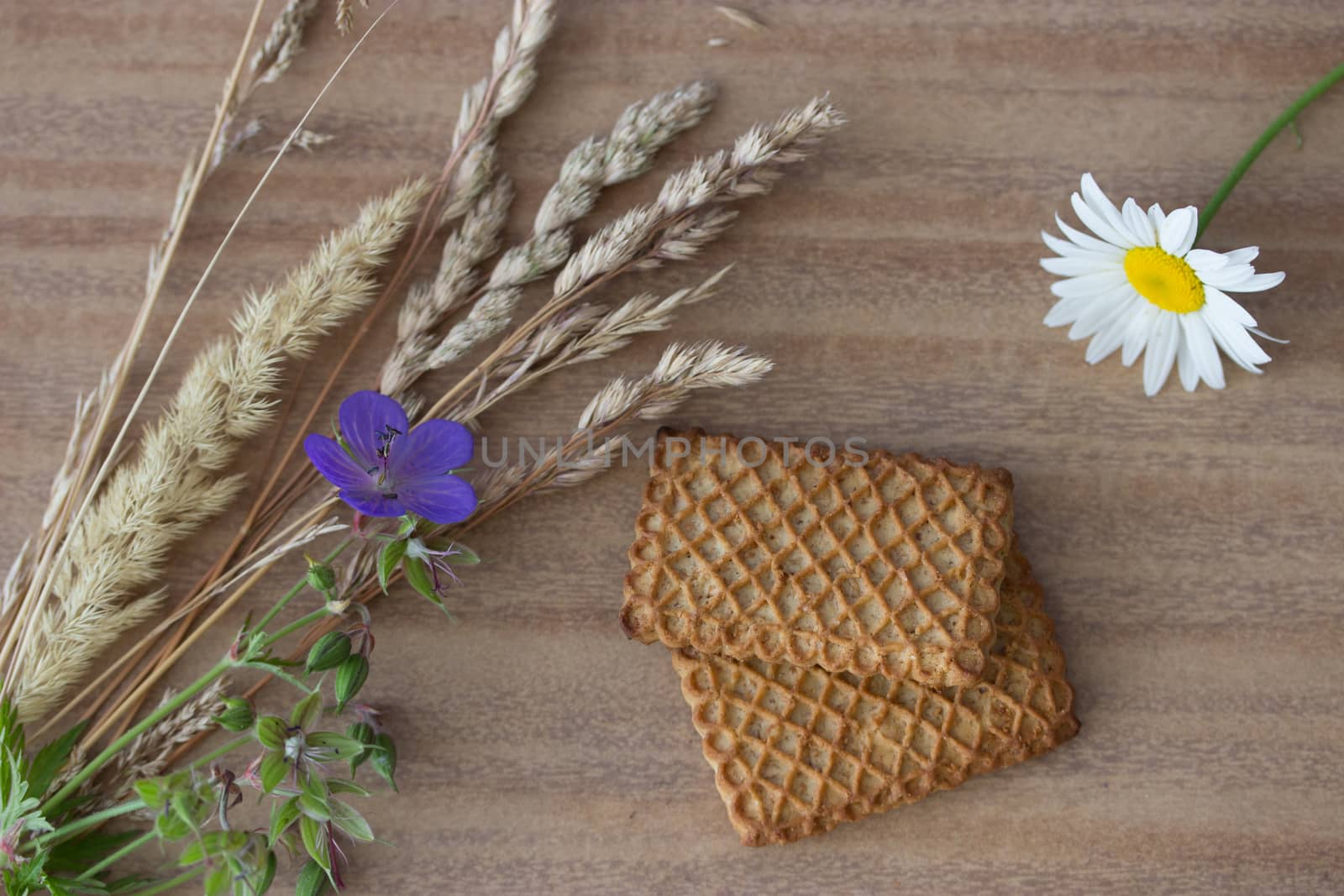 fresh crispy cereal cookies ears and flowers on rustic wooden table