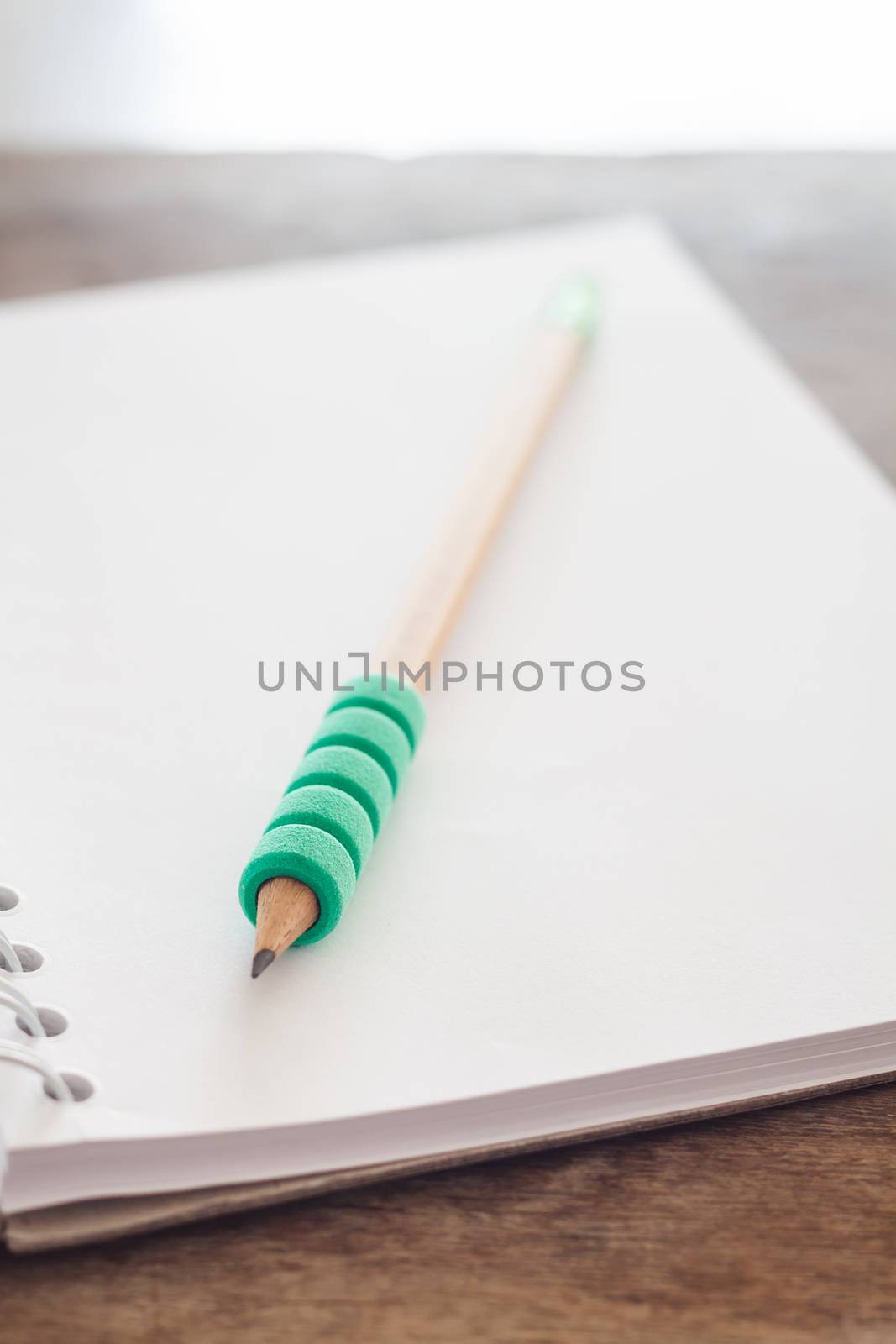 Pencil on open blank notebook, stock photo